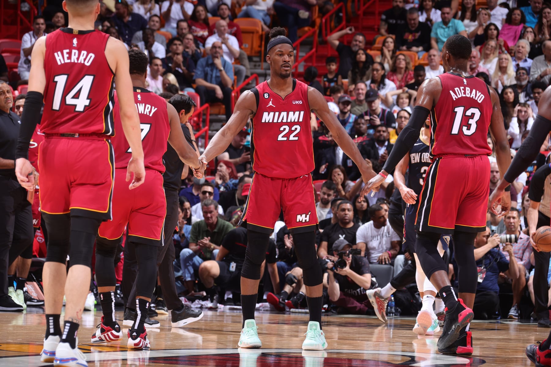 MIAMI, FL - JANUARY 22: Jimmy Butler #22 of the Miami Heat high fives Kyle Lowry #7 and Bam Adebayo #13 during the game against the New Orleans Pelicans on January 22, 2023 at Miami-Dade Arena in Miami, Florida. NOTE TO USER: User expressly acknowledges and agrees that, by downloading and or using this Photograph, user is consenting to the terms and conditions of the Getty Images License Agreement. Mandatory Copyright Notice: Copyright 2023 NBAE (Photo by Nathaniel S. Butler/NBAE via Getty Images)