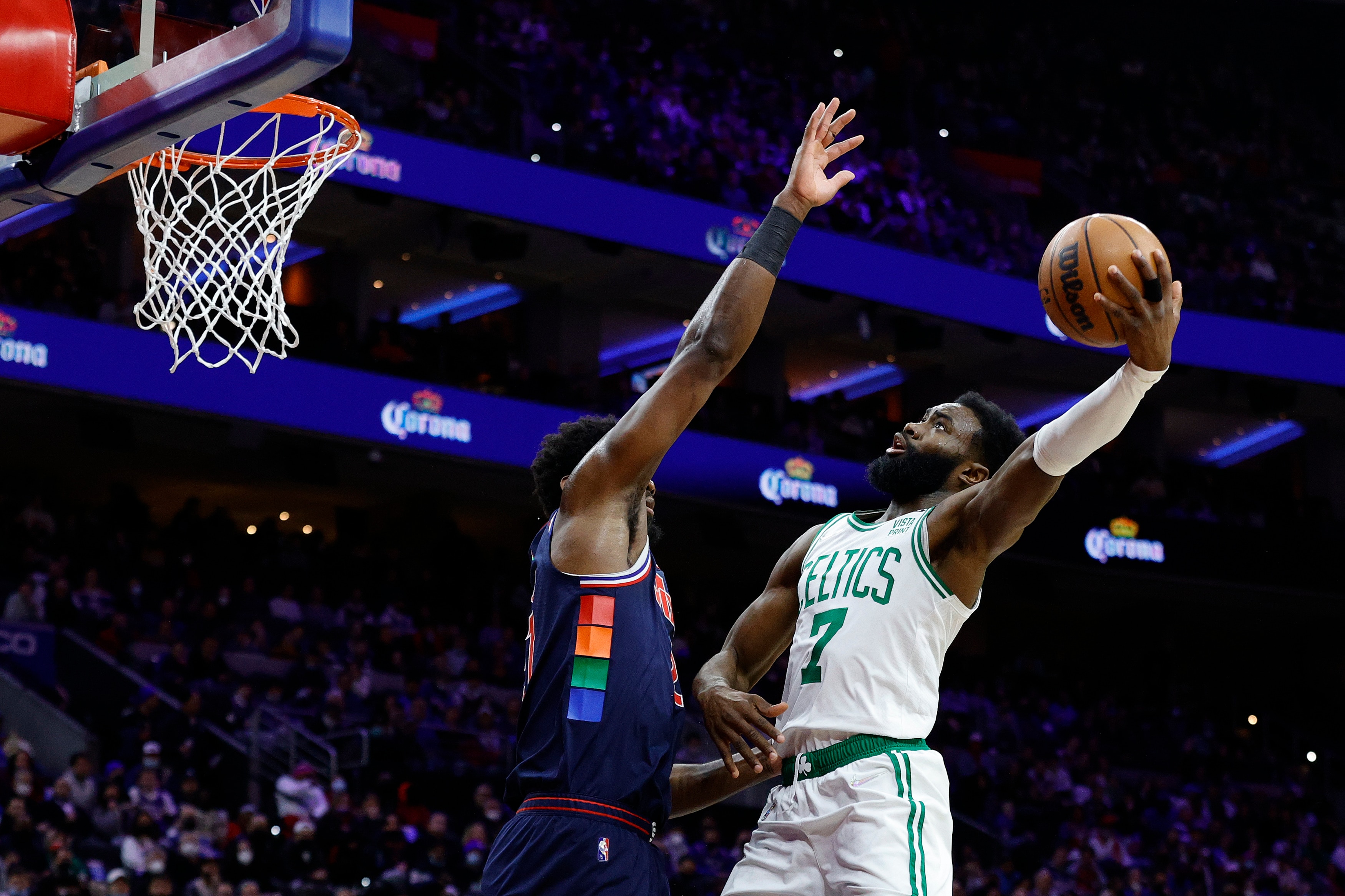 PHILADELPHIA, PENNSYLVANIA - FEBRUARY 15: Jaylen Brown #7 of the Boston Celtics shoots over Joel Embiid #21 of the Philadelphia 76ers during the first quarter shoots over  at Wells Fargo Center on February 15, 2022 in Philadelphia, Pennsylvania. NOTE TO USER: User expressly acknowledges and agrees that, by downloading and or using this photograph, User is consenting to the terms and conditions of the Getty Images License Agreement. (Photo by Tim Nwachukwu/Getty Images)