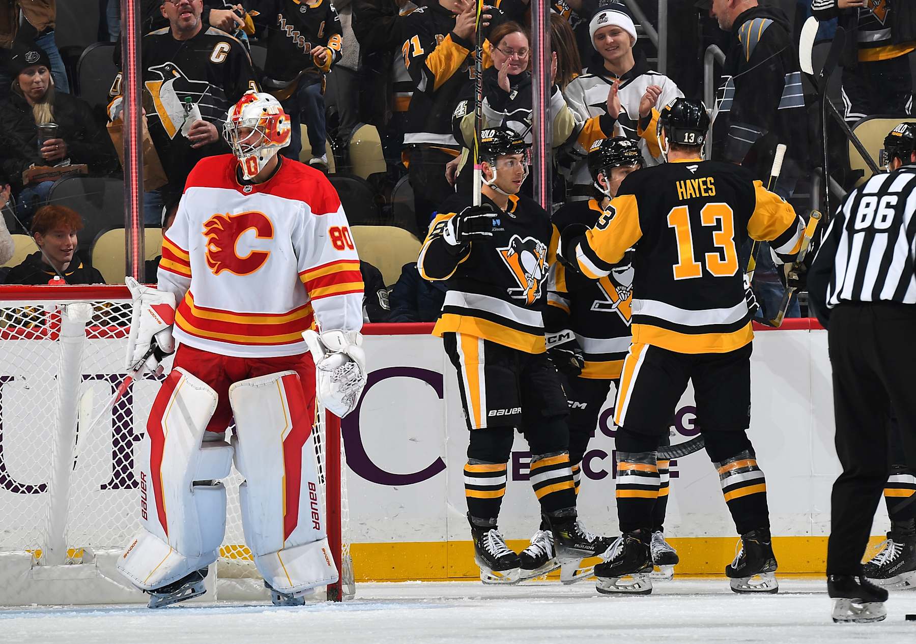 PITTSBURGH, PA - NOVEMBER 30:  Michael Bunting #8 celebrates his goal with Kevin Hayes #13 and Philip Tomasino #53 of the Pittsburgh Penguins during the second period against the Calgary Flames at PPG PAINTS Arena on November 30, 2024 in Pittsburgh, Pennsylvania. (Photo by Joe Sargent/NHLI via Getty Images)