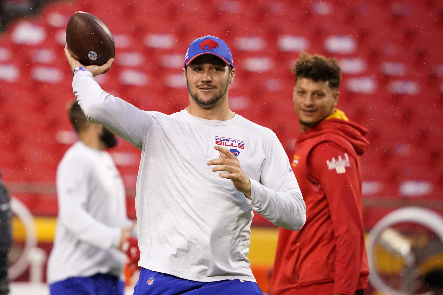 Buffalo Bills quarterback Josh Allen, left, warms up as Kansas City Chiefs quarterback Patrick Mahomes, right, watches before the start of an NFL football game Sunday, Oct. 10, 2021, in Kansas City, Mo. (AP Photo/Ed Zurga)