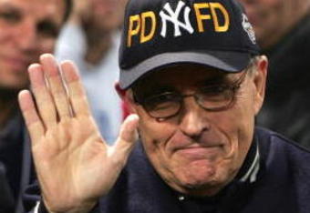 BOSTON - OCTOBER 17:  Former New York City mayor Rudy Giuliani and Yankees fan waves during game four of the American League Championship Series against the Boston Red Sox on October 17, 2004 at Fenway Park in Boston, Massachusetts.  (Photo by Jed Jacobso