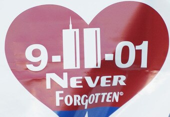 BRONX, NY - SEPTEMBER 11:  Fans of the New York Yankees hold up a sign '9/11/01 never forget' to commemorate the anniversary of 9/11 during game against the Baltiomore Orioles on September 11, 2002 at Yankee Stadium in the Bronx, New York. The Yankees def