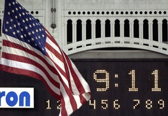 BRONX, NY - SEPTEMBER 11:   The American Flag flies at half staff near the scoreboard during the moment of silence at 9:11 p.m. as the New York Yankees played the Baltimore Orioles on September 11, 2002 at Yankee Stadium in the Bronx, New York. (Photo by 