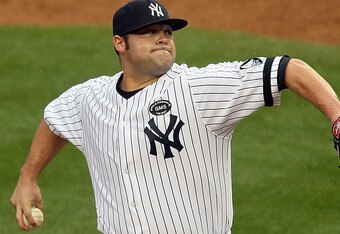 NEW YORK - AUGUST 22:  Joba Chamberlain #62 of the New York Yankees delivers a pitch against the Seattle Mariners on August 22, 2010 at Yankee Stadium in the Bronx borough of New York City.The Yankees defeated the Mariners 10-0.  (Photo by Jim McIsaac/Get