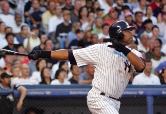 NEW YORK - JULY 14:  Bernie Williams #51 of the New York Yankees hits a sacrifice fly to score Jason Giambi #25 in the fourth inning as Chris Widger #36 of the Chicago White Sox and umpire Paul Emmel look on July 14, 2006 at Yankee Stadium in the Bronx bo