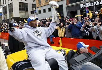 PITTSBURGH - FEBRUARY 03:  James Harrison #92 of the Pittsburgh Steelers shows off the Super Bowl XLIII trophy during a parade on February 3, 2009 in Pittsburgh, Pennsylvania.  (Photo by Gregory Shamus/Getty Images)