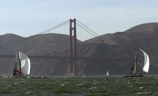 SAN FRANCISCO - SEPTEMBER 16:  Swiss Team Alinghi headed by Ernesto Bertarelli (left) and Oracle BMW Racing team headed by Larry Ellison race in front of the Golden Gate Bridge during the Moet Cup in the San Francisco Bay on September 16, 2003 in San Fran