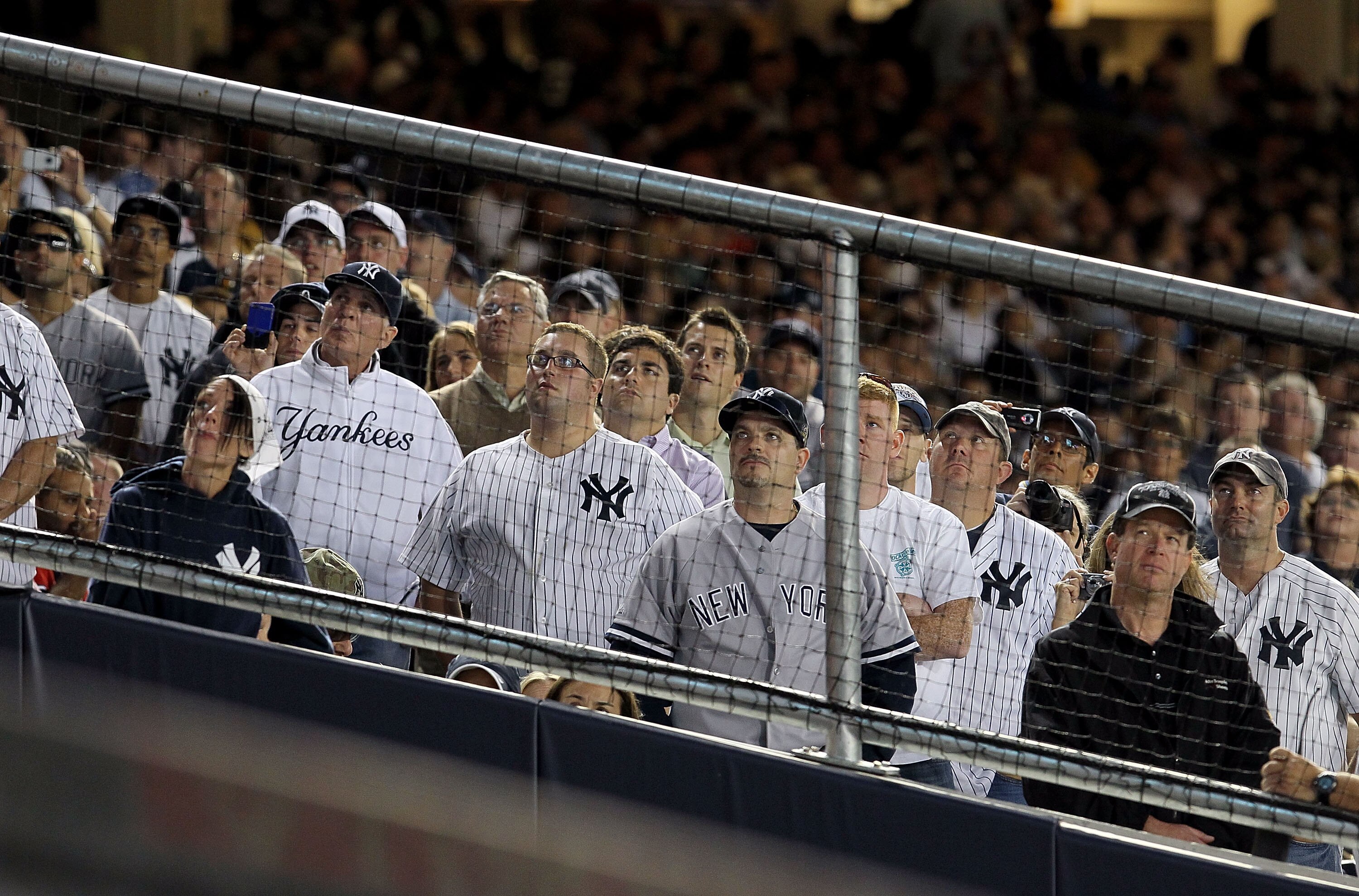 NEW YORK - SEPTEMBER 20: Fans of the New York Yankees watch a video tribute to the late team owner George Steinbrenner prior to the game against the Tampa Bay Rays on September 20, 2010 at Yankee Stadium in the Bronx borough of New York City.  (Photo by J