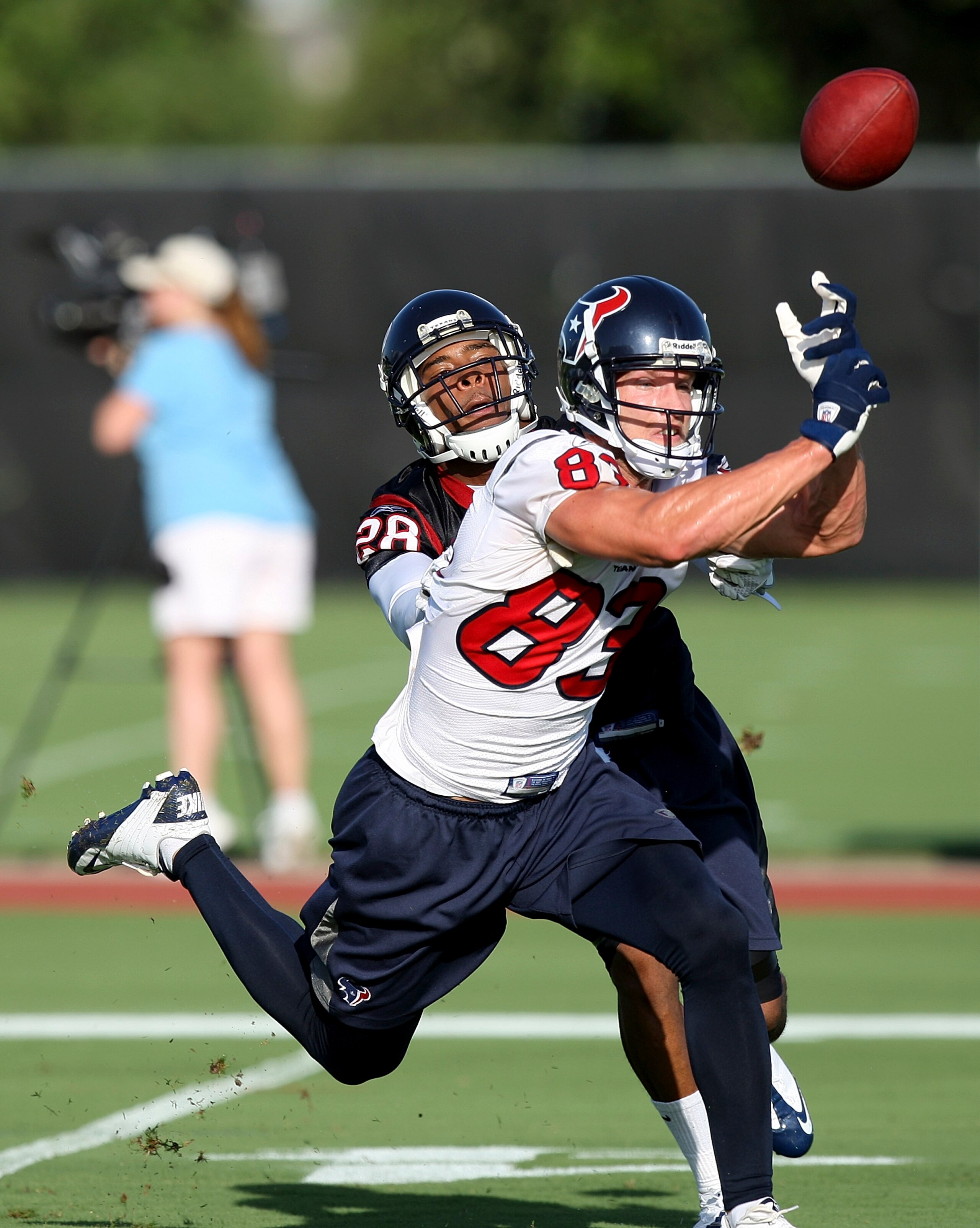 HOUSTON - JULY 30:  Wide receiver Kevin Walter #83 of the Houston Texans misses a pass as he is defended by  cornerback Antwaun Molden #28 during the team's first NFL training camp practice of the season at Reliant Park on July 30, 2010 in Houston, Texas.