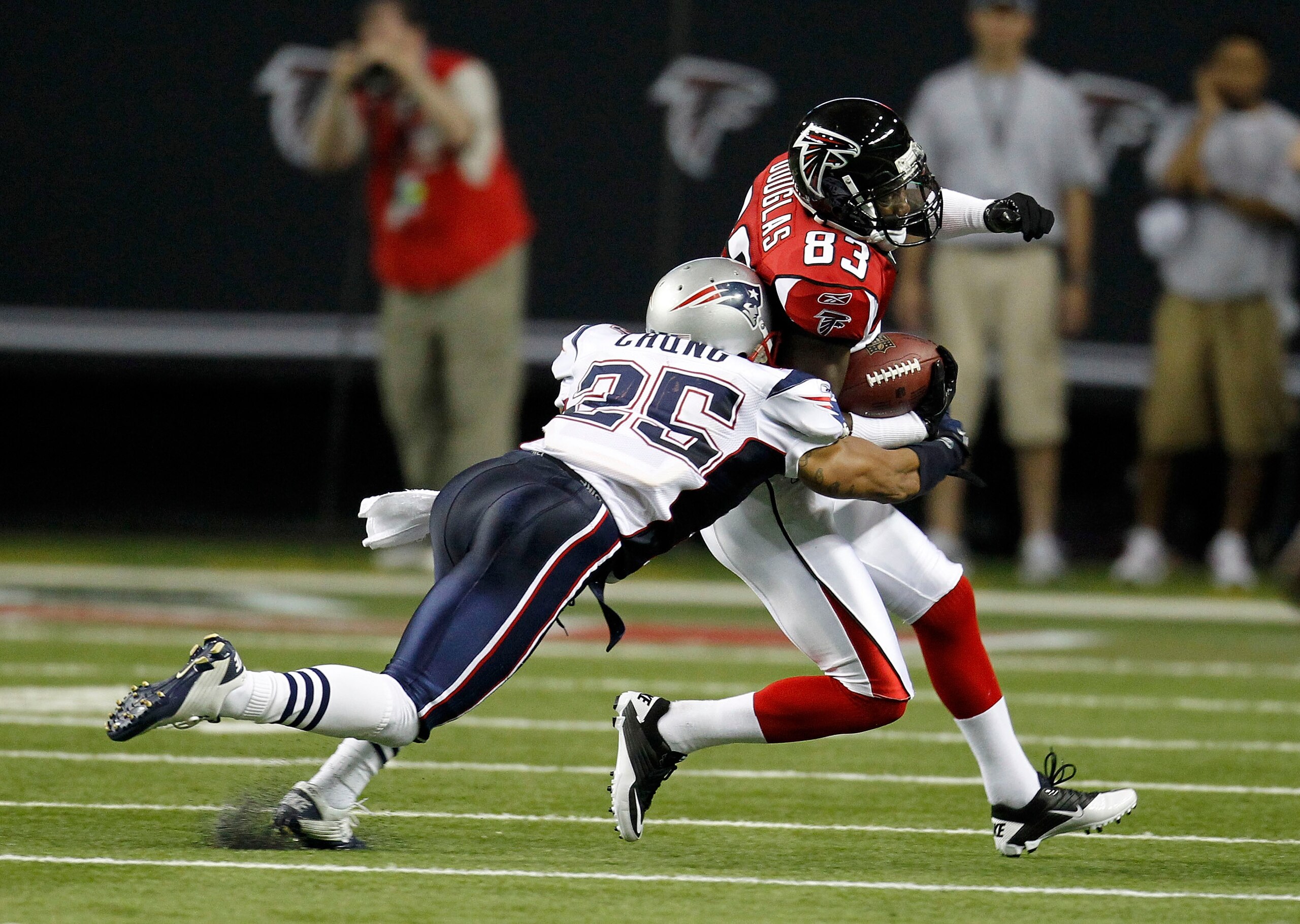 ATLANTA - AUGUST 19:  Wide receiver Harry Douglas #83 of the Atlanta Falcons is tackled by safety Patrick Chung #25 of the New England Patriots during the preseason game at the Georgia Dome on August 19, 2010 in Atlanta, Georgia.  (Photo by Mike Zarrilli/