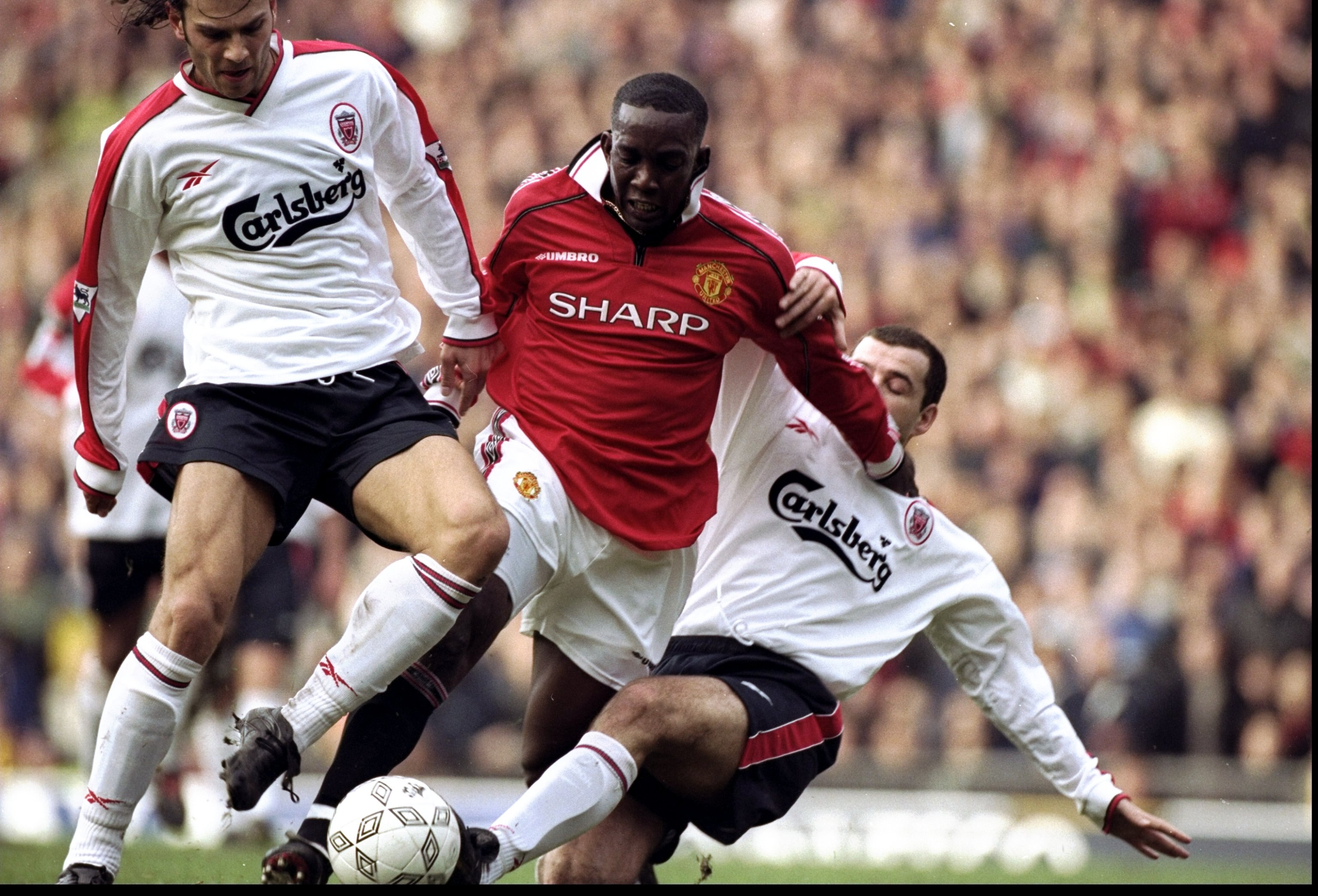 24 Jan 1999:  Dwight Yorke of Manchester United is taken out by Patrik Berger and Steve Harkness of Liverpool during the FA Cup fourth round clash at Old Trafford in Manchester, England. United won 2-1. \ Mandatory Credit: Ross Kinnaird /Allsport