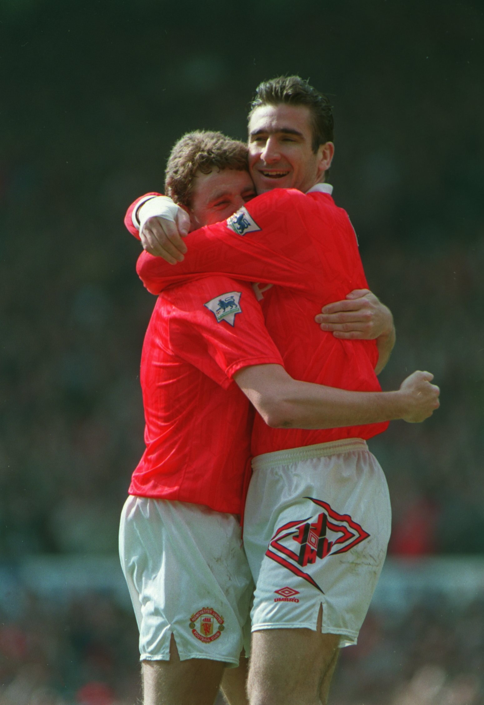 12 APR 1993:  A PICTURE SHOWING ERIC CANTONA OF  MANCHESTER UNITED SOCCER CLUB AS HE CELEBRATES A GOAL WITH TEAMMATE STEVE BRUCE DURING THEIR MATCH AGAINST CHELSEA Mandatory Credit: Steve Morton/ALLSPORT