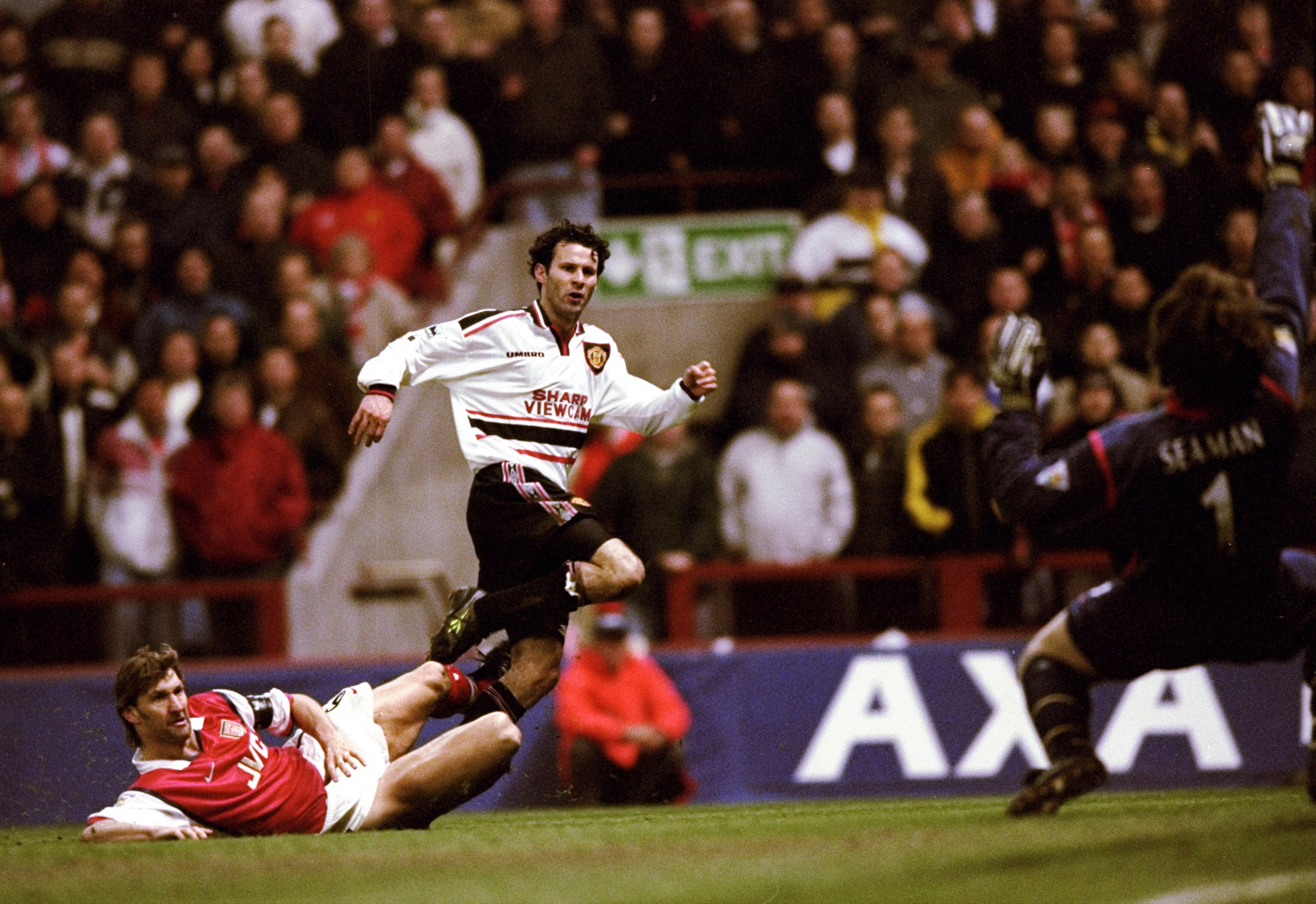 14 Apr 1999:  Ryan Giggs of Manchester United beats the despairing lunge of Tony Adams of Arsenal to drive the ball past David Seaman to score the winner in the FA Cup Semi Final match played at Villa Park in Birmingham. Manchester United won the game 2-1