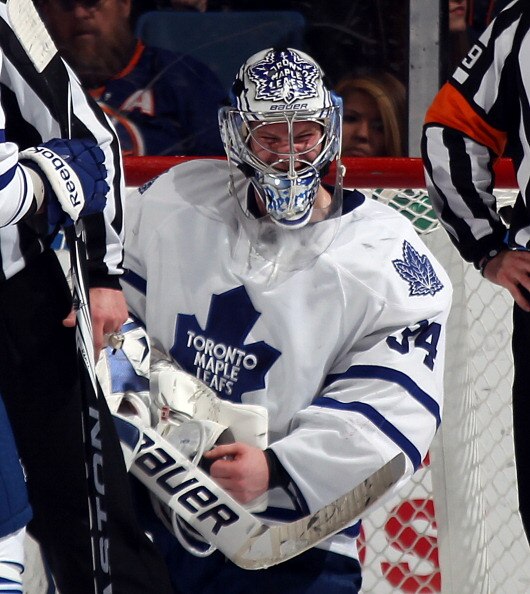 UNIONDALE, NY - MARCH 08: After a hand injury, goaltender James Reimer #34 of the Toronto Maple Leafs waits to be attended to by a trainer in the third period of his game against the New York Islanders at the Nassau Coliseum on March 8, 2011 in Uniondale,