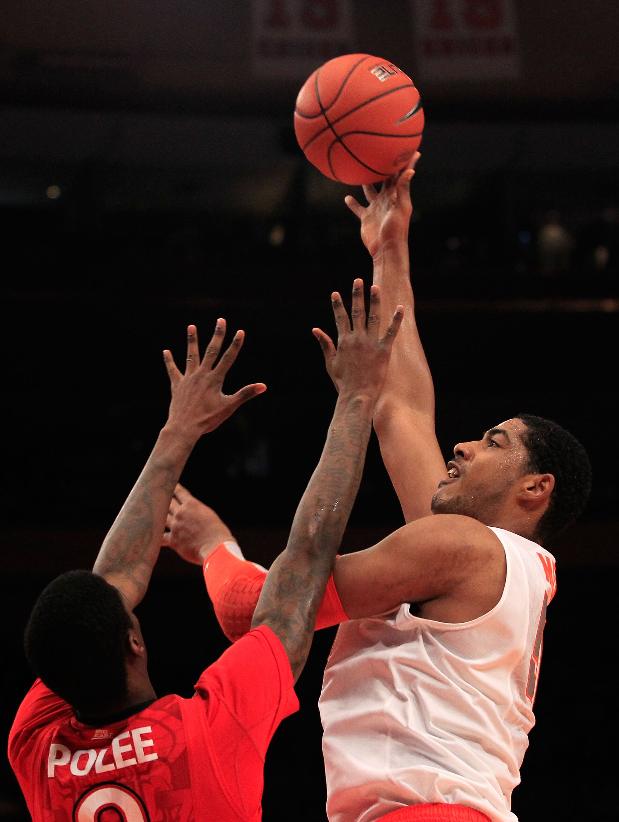 NEW YORK, NY - MARCH 10: Fab Melo #51 of the Syracuse Orange shoots over Dwayne Polee Jr. #0 of the St. John's Red Storm during the quarterfinals of the 2011 Big East Men's Basketball Tournament presented by American Eagle Outfitters  at Madison Square Ga