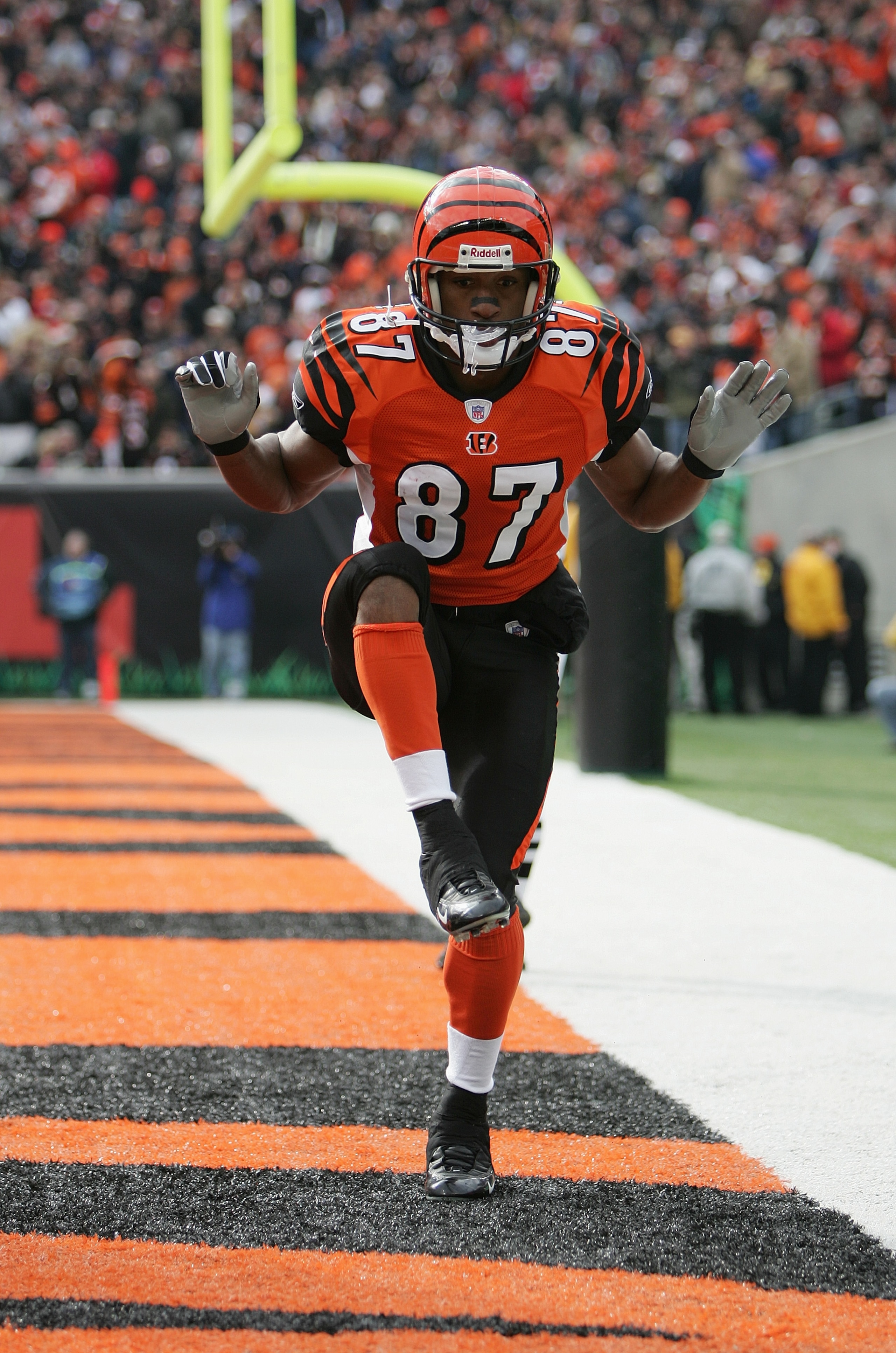 CINCINNATI - DECEMBER 24:  Kelley Washington #87 of the Cincinnati Bengals runs with the ball after a reception and is tackled by Nate Clements #22 of the Buffalo Bills at Paul Brown Stadium on December 24, 2005 in Cincinnati, Ohio.  The Bills won 37-27.
