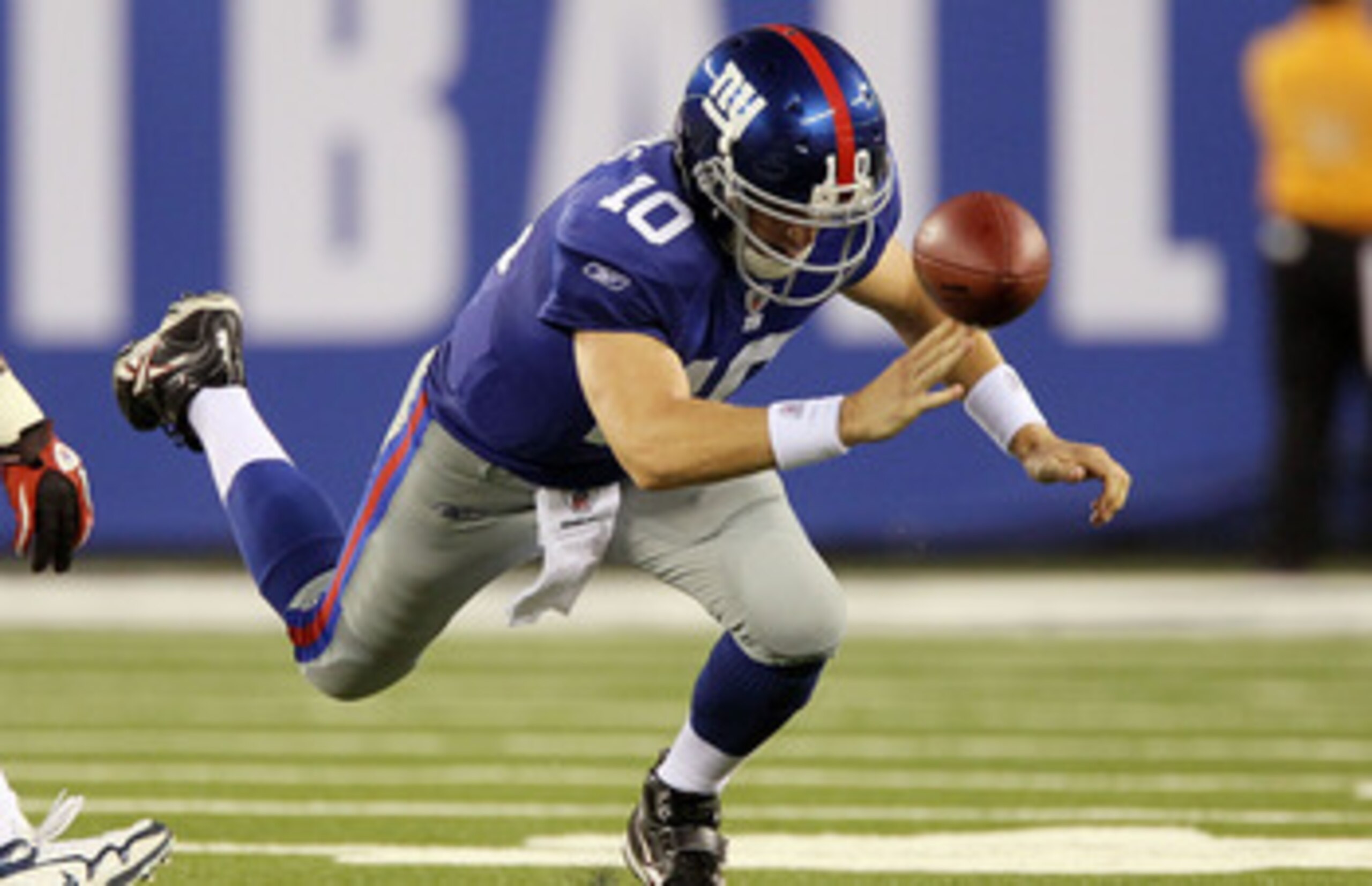 EAST RUTHERFORD, NJ - SEPTEMBER 02:  Eli Manning #10 of the New York Giants fumbles the ball in the first quarter against the New England Patriots on September 2, 2010 at the New Meadowlands Stadium in East Rutherford, New Jersey.  (Photo by Jim McIsaac/G