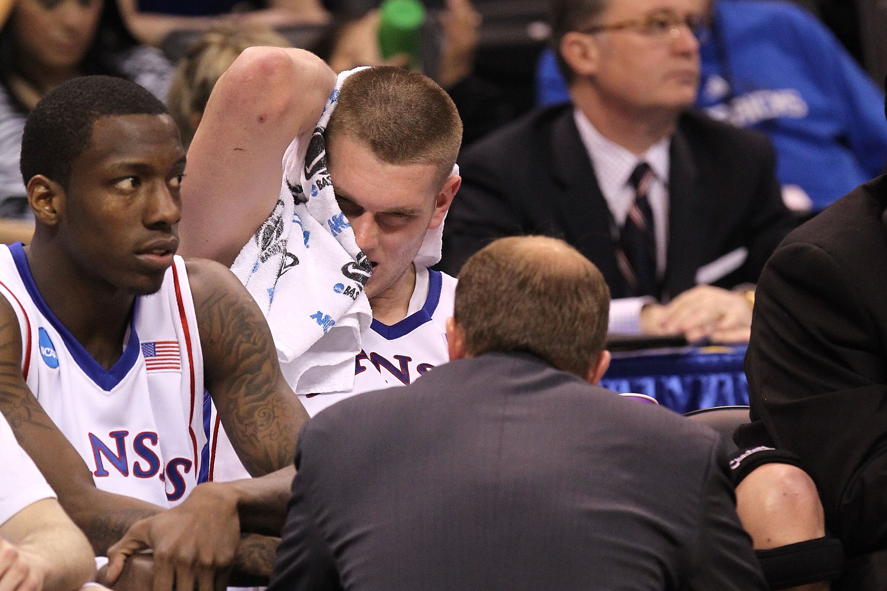 OKLAHOMA CITY - MARCH 20:  Cole Aldrich #45 of the Kansas Jayhawks covers his face with a towel as he has his leg tended to on the bench against the Northern Iowa Panthers during the second round of the 2010 NCAA men's basketball tournament at Ford Center