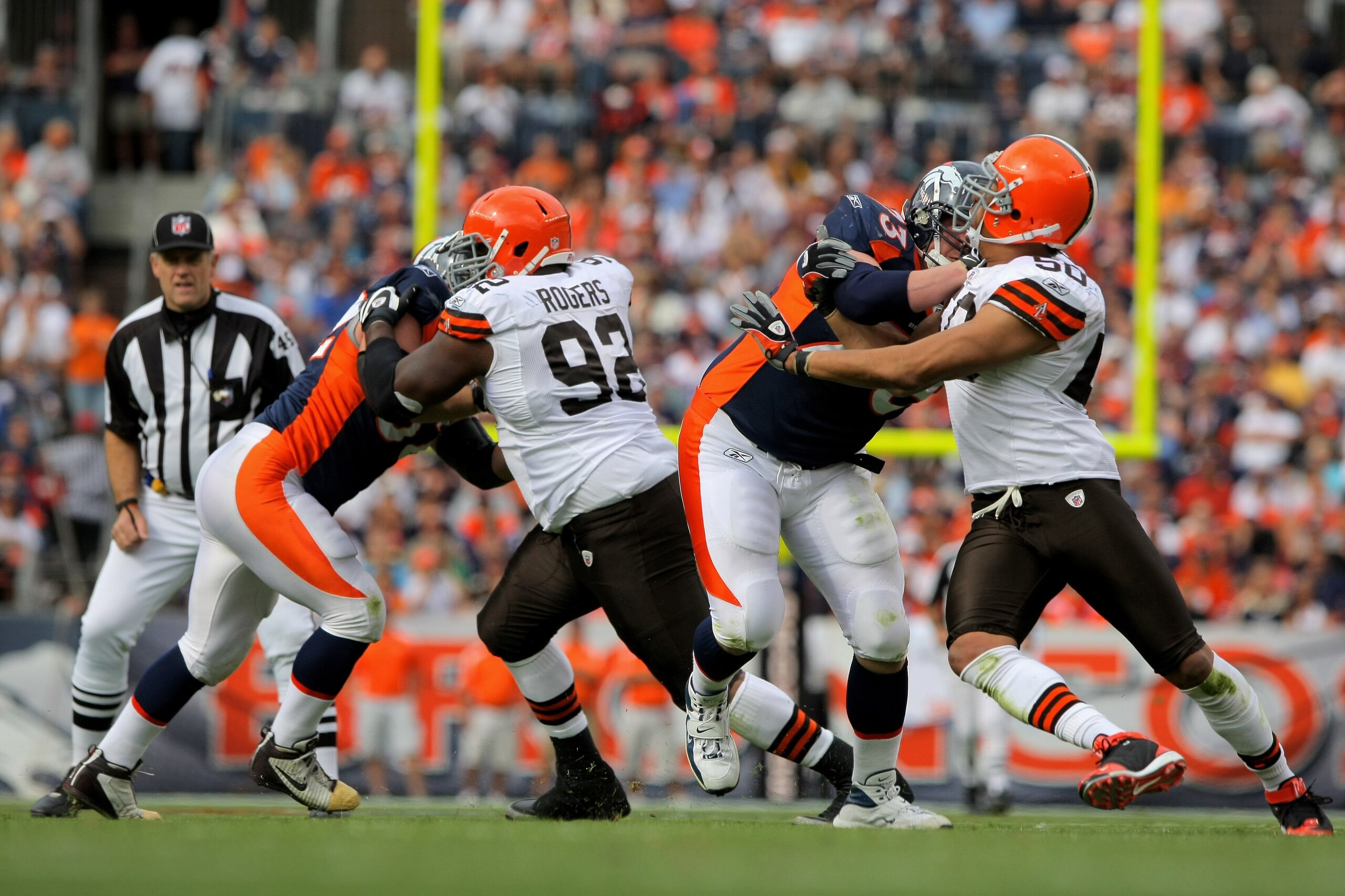 DENVER - SEPTEMBER 20:  Defensive lineman Shaun Rogers #92 and linebacker Eric Barton #50 of the Cleveland Browns rush against center Casey Wiegmann #62 and offensive tackle Chris Kuper #73 of the Denver Broncos during NFL action at Invesco Field at Mile