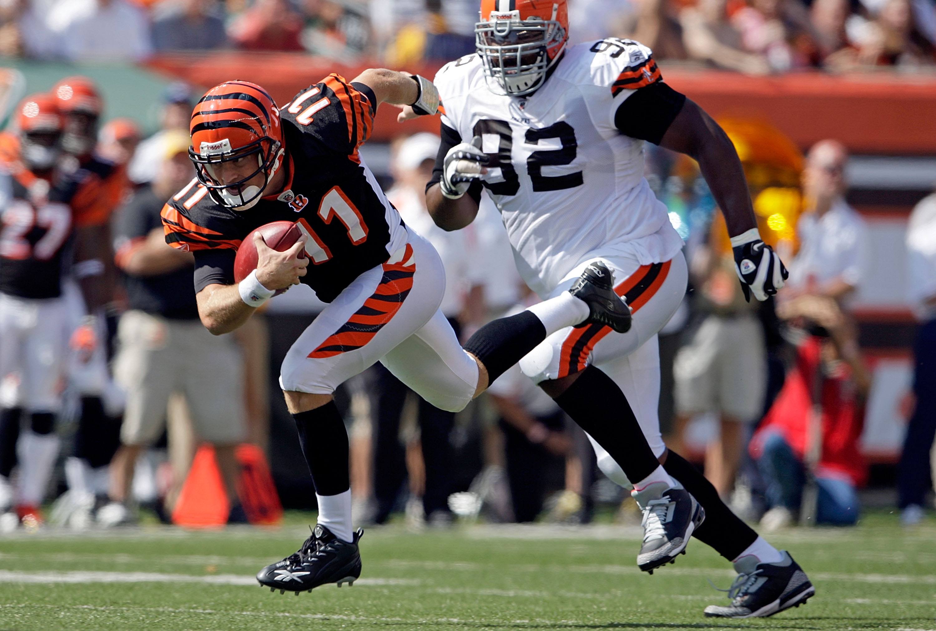 CINCINNATI - SEPTEMBER 28:  Ryan Fitzpatrick #11 of the Cincinnati Bengals runs with the ball while defended by Shaun Rogers #92 of the Cleveland Browns during the NFL game on September 28, 2008 at Paul Brown Stadium in Cincinnati, Ohio.  (Photo by Andy L