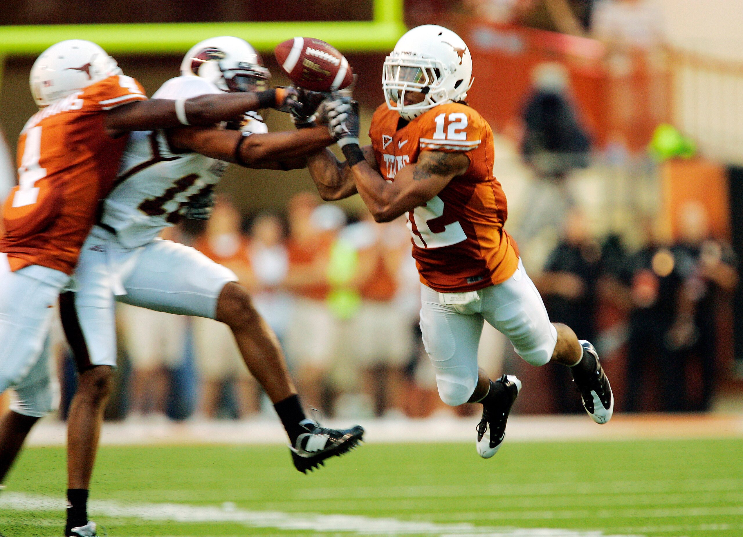AUSTIN, TX - SEPTEMBER 5:  Safety Earl Thomas #12 of the Texas Longhorns nrearly intercepts a pass intended for Tim Taylor #10 of the Louisiana Monroe Warhawks as defensive back  Aaron Williams #4 gets his hand in on the play in the second quarter on Sept