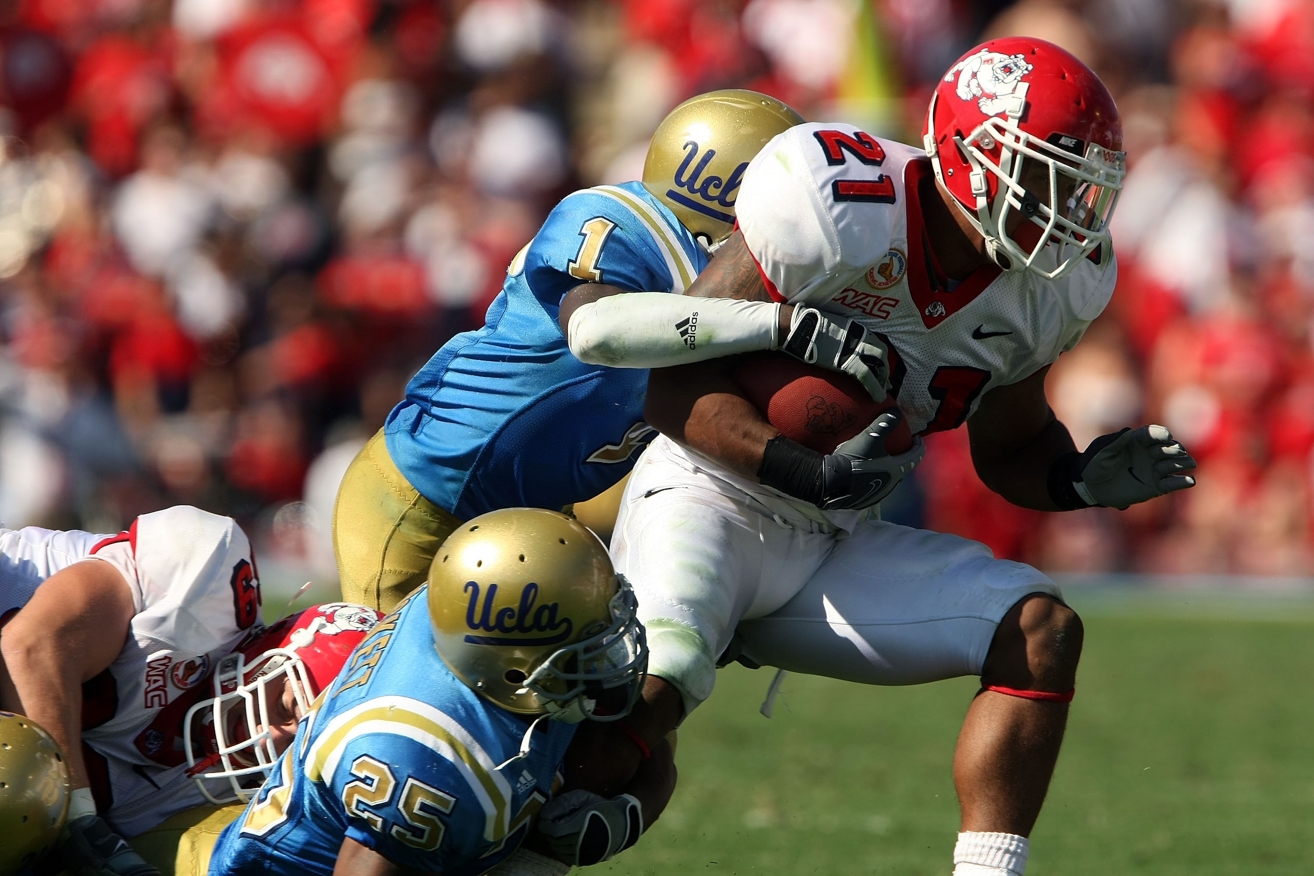 PASADENA, CA - SEPTEMBER 27:  Ryan Matthews #21 of the Frenso State Bulldogs tires to break a tackle by Alterraun Verner #1 and Bret Lockett #25 of the UCLA Bruins during the game on September 27, 2008 at the Rose Bowl in Pasadena, California.  (Photo by 