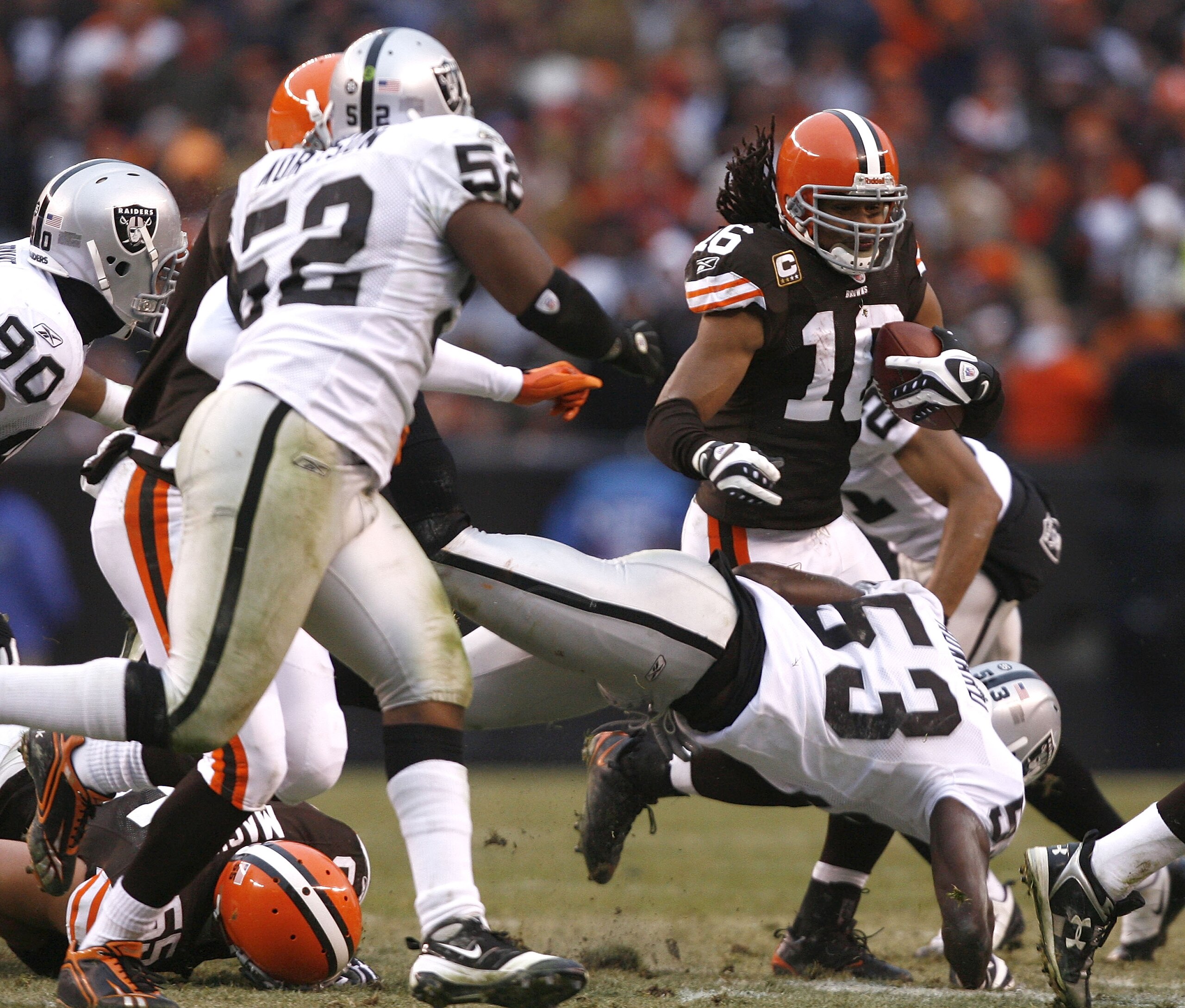 CLEVELAND - DECEMBER 27:  Joshua Cribbs #16 of the Cleveland Browns runs into Kirk Morrison #52 and Thomas Howard #53 of the Oakland Raiders at Cleveland Browns Stadium on December 27, 2009 in Cleveland, Ohio.  (Photo by Matt Sullivan/Getty Images)