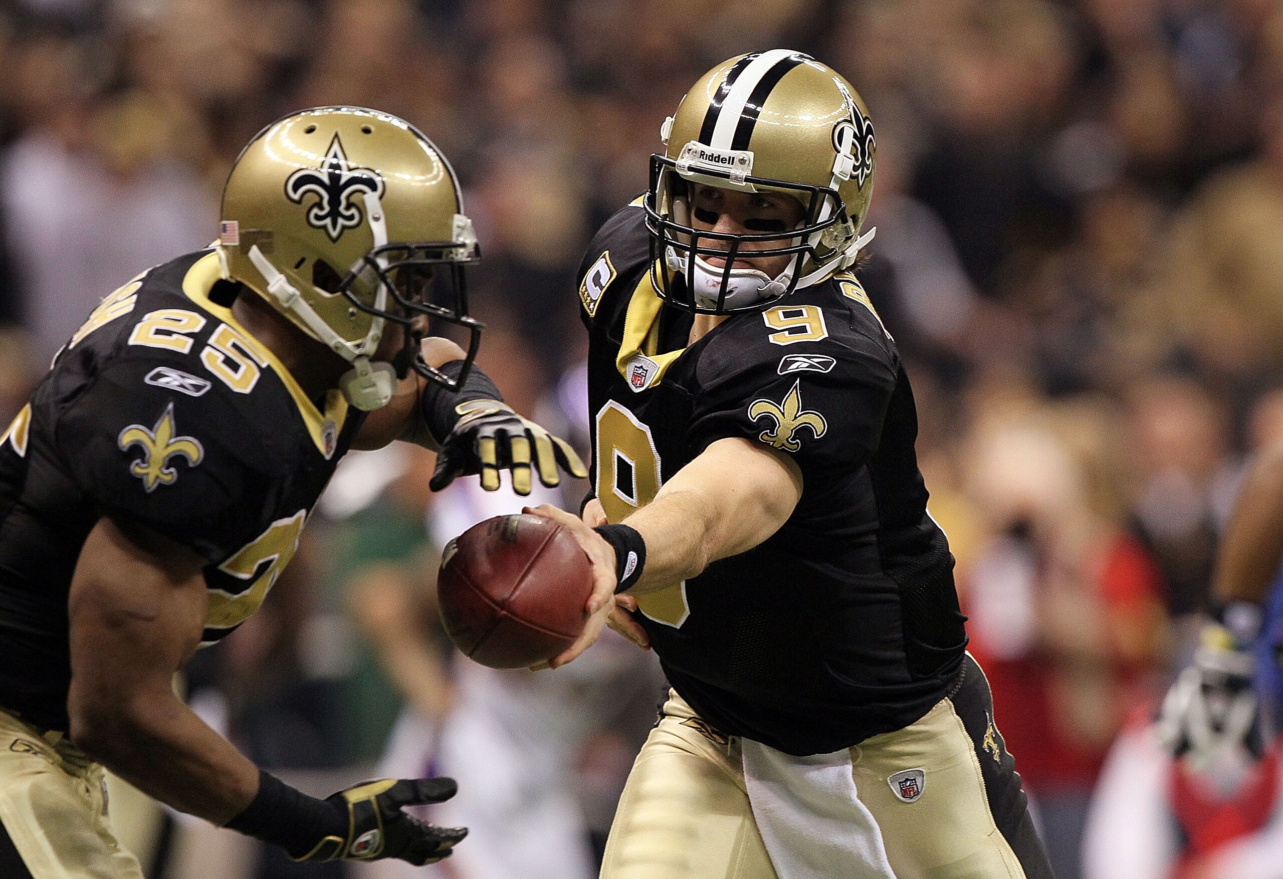 NEW ORLEANS - JANUARY 24: Quarterback Drew Brees #9 of the New Orleans Saints hands the ball off to Reggie Bush #25 against the Minnesota Vikings during the NFC Championship Game at the Louisana Superdome on January 24, 2010 in New Orleans, Louisiana. ( NEW ORLEANS - JANUARY 24: Quarterback Drew Brees #9 of the New Orleans Saints hands the ball off to Reggie Bush #25 against the Minnesota Vikings during the NFC Championship Game at the Louisana Superdome on January 24, 2010 in New Orleans, Louisiana. (