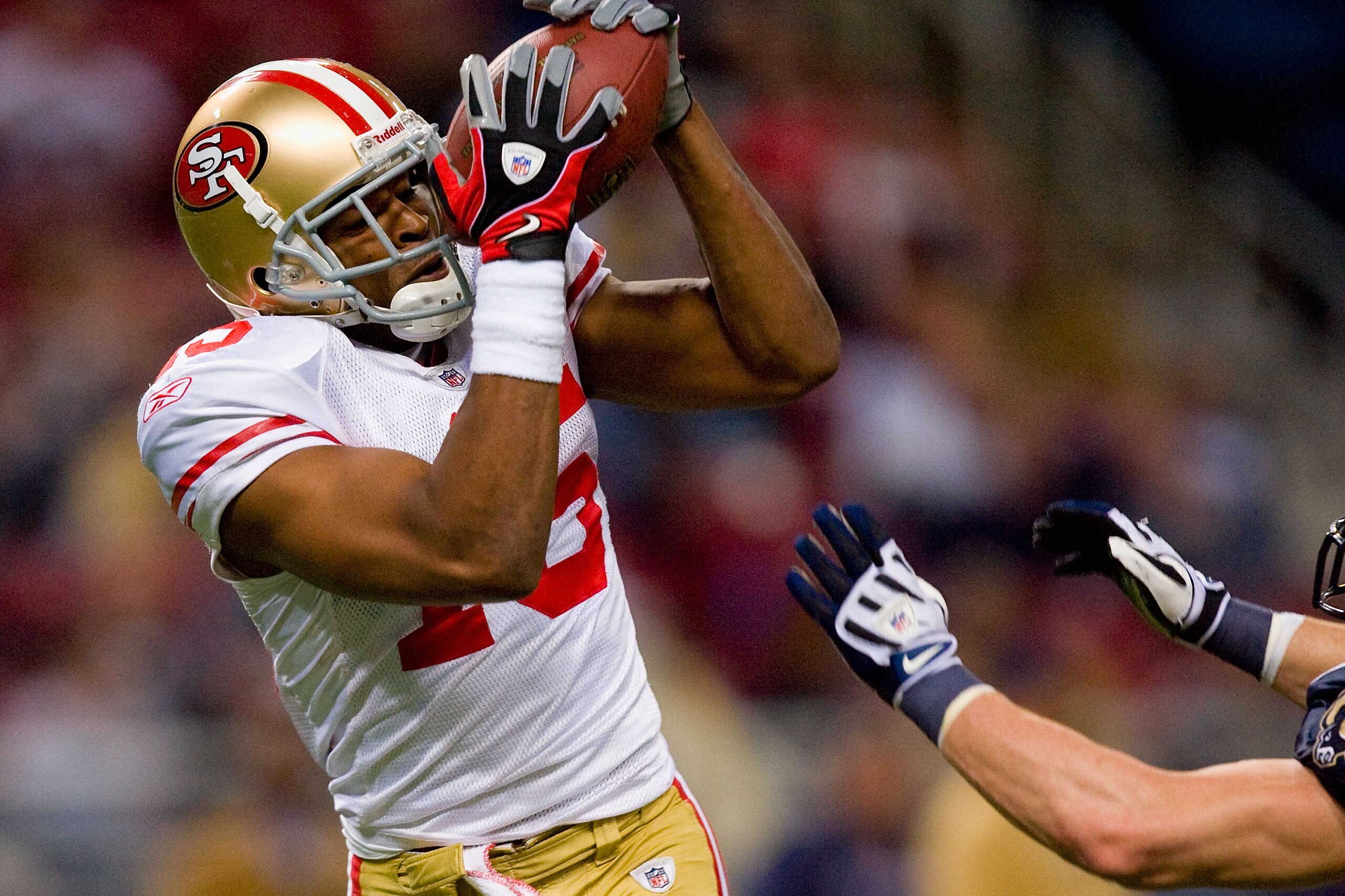 ST. LOUIS - JANUARY 3: Michael Crabtree #15 of the San Francisco 49ers hauls in a pass against the St. Louis Rams at the Edward Jones Dome on January 3, 2010 in St. Louis, Missouri.  The 49ers beat the Rams 28-6.  (Photo by Dilip Vishwanat/Getty Images)