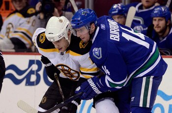 VANCOUVER, CANADA - FEBRUARY 26: Alexandre Burrows #14 of the Vancouver Canucks gets in close to Milan Lucic #17 of the Boston Bruins on a face-off during the third period in NHL action on February 26, 2011 at Rogers Arena in Vancouver, British Columbia, 