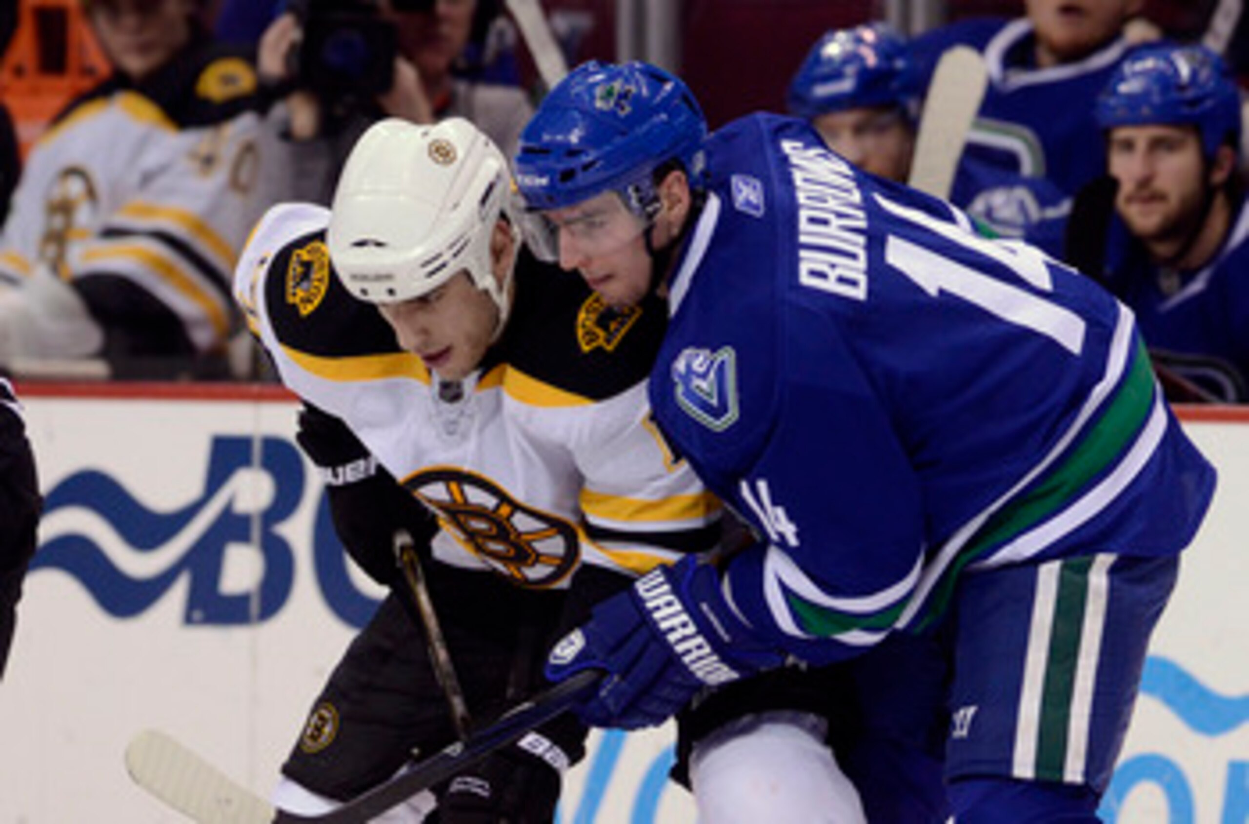 VANCOUVER, CANADA - FEBRUARY 26: Alexandre Burrows #14 of the Vancouver Canucks gets in close to Milan Lucic #17 of the Boston Bruins on a face-off during the third period in NHL action on February 26, 2011 at Rogers Arena in Vancouver, British Columbia, 