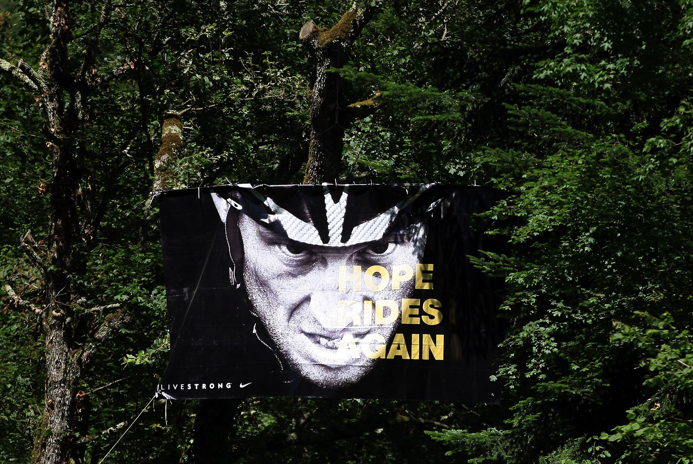 BAGNERES-DE-LUCHON, FRANCE - JULY 19:  A banner supporting Lance Armstrong hangs in a tree on during stage fifteen of the 2010 Tour de France from Pamiers to Bagneres-de-Luchon on July 19, 2010 in Bagneres-de-Luchon, France.  (Photo by Bryn Lennon/Getty I