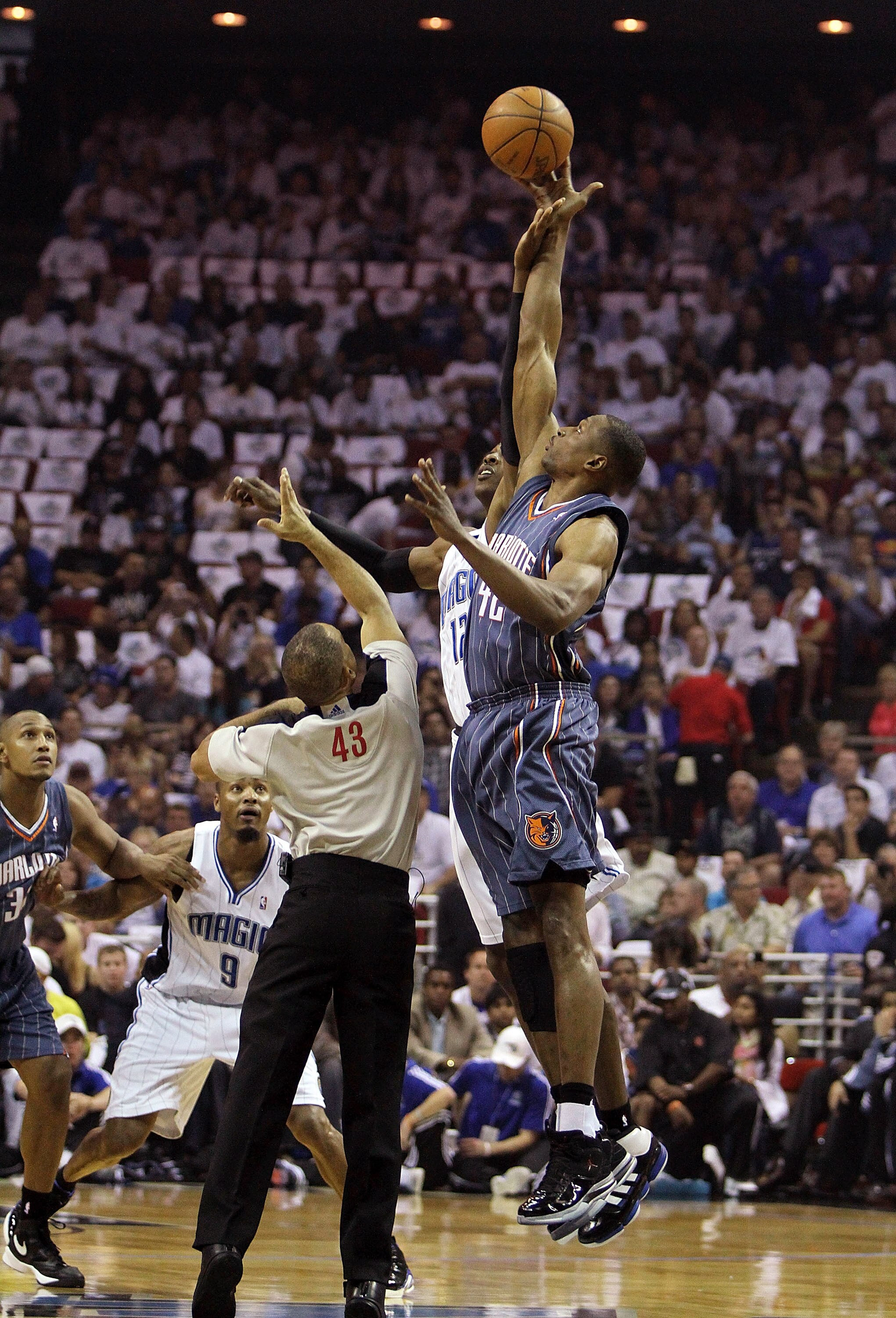 ORLANDO, FL - APRIL 18:  Theo Ratliff #42 of the Charlotte Bobcats gets the opening tip over Dwight Howard #12 of the Orlando Magic after being tossed into the air by official Dan Crawford  #43 in Game One of the Eastern Conference Quarterfinals during th