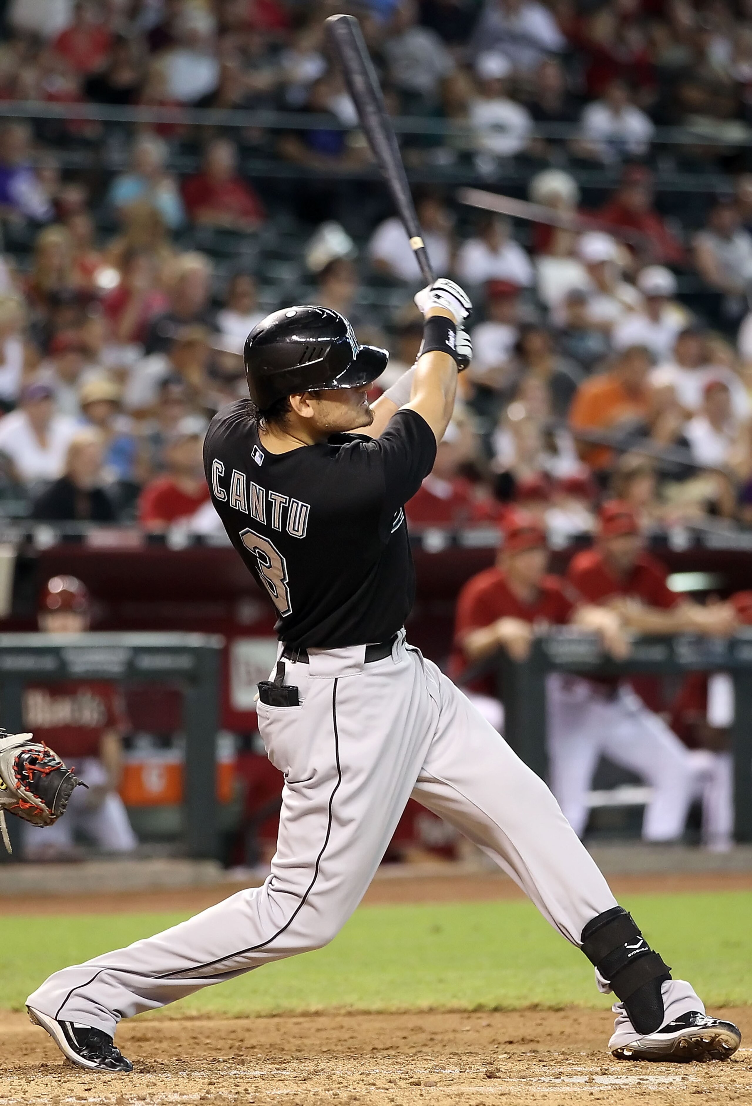 PHOENIX - JULY 11:  Jorge Cantu #3 of the Florida Marlins hits a RBI double against the Arizona Diamondbacks during the fourth inning of the Major League Baseball game at Chase Field on July 11, 2010 in Phoenix, Arizona.  (Photo by Christian Petersen/Gett