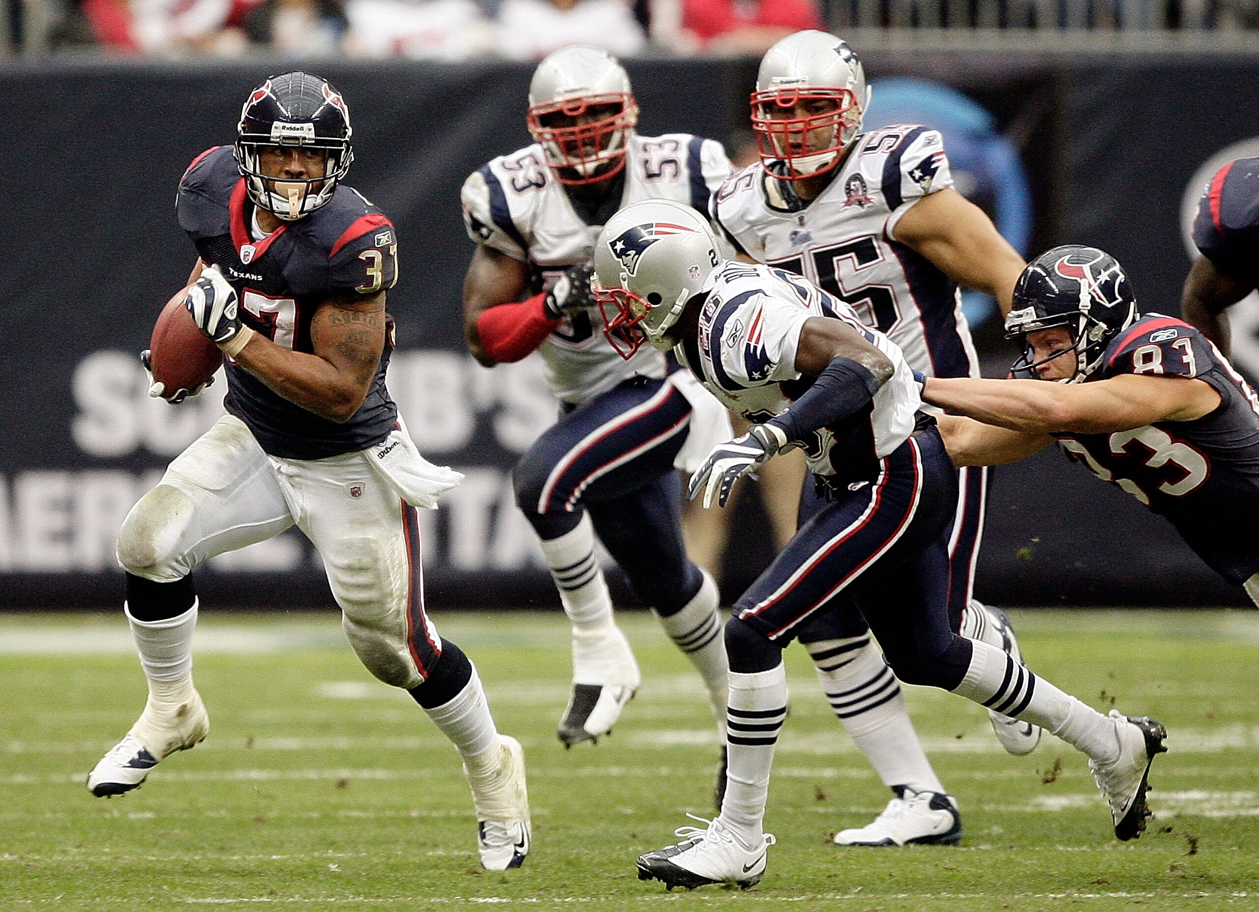 HOUSTON - JANUARY 03:  Running back Arian Foster #37 of the Houston Texans rushes along the sideline as safety Brandon Meriweather #31 of the New England Patriots looks to make the tackle at Reliant Stadium on January 3, 2010 in Houston, Texas.  (Photo by