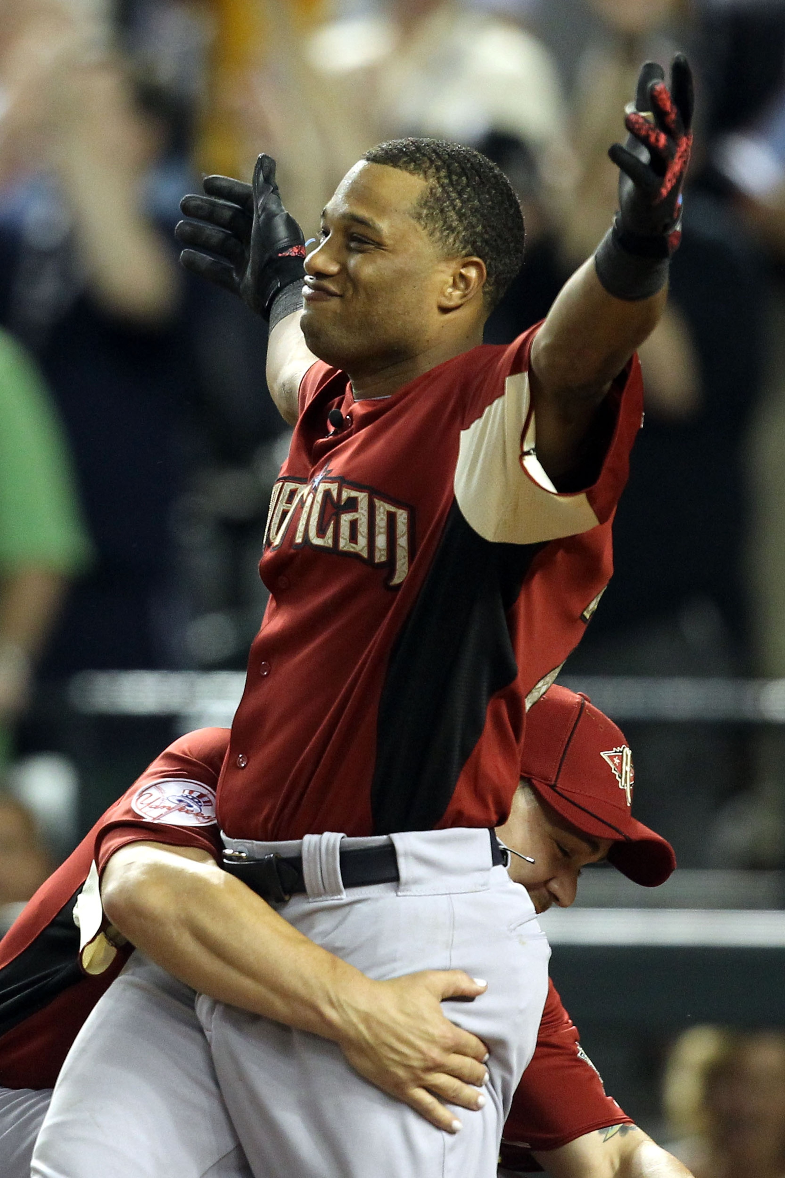 PHOENIX, AZ - JULY 11:  American League All-Star Robinson Cano #24 of the New York Yankees reacts with teammate Russell Martin #55 of the New York Yankees after winning the 2011 State Farm Home Run Derby at Chase Field on July 11, 2011 in Phoenix, Arizona