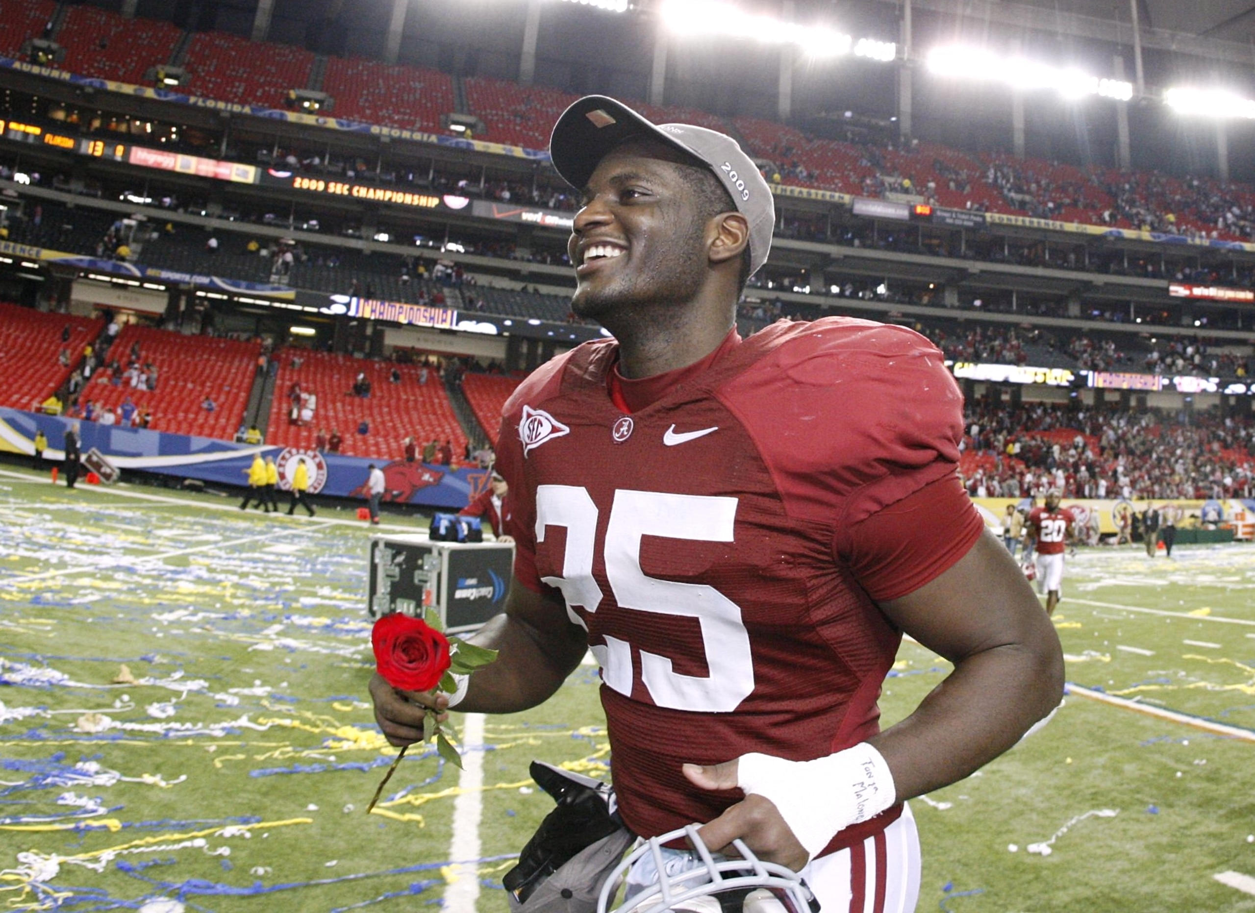 ATLANTA - DECEMBER 5:  Rolando McClain #25 of the Alabama Crimson Tide carries a rose as he runs of the field after their 32-13 win against the Florida Gators during the SEC Championship game at Georgia Dome on December 5, 2009 in Atlanta, Georgia.  (Phot