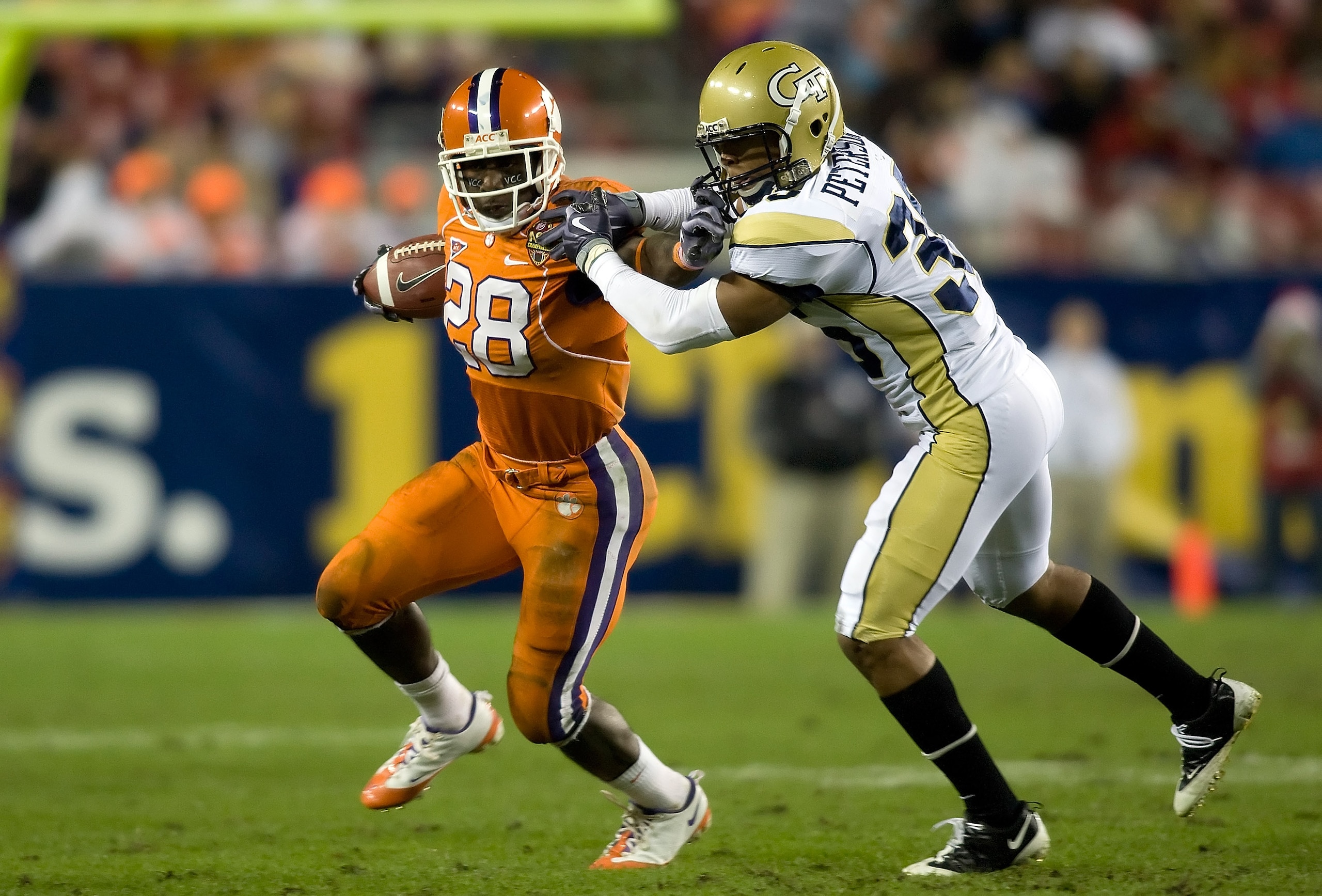 TAMPA - DECEMBER 05:  Running back C.J. Spiller #28 of the Clemson Tigers runs the ball as defensive back Michael Peterson #35 of the Georgia Tech Yellow Jackets tries to bring him down in the 2009 ACC Football Championship game at Raymond James Stadium o