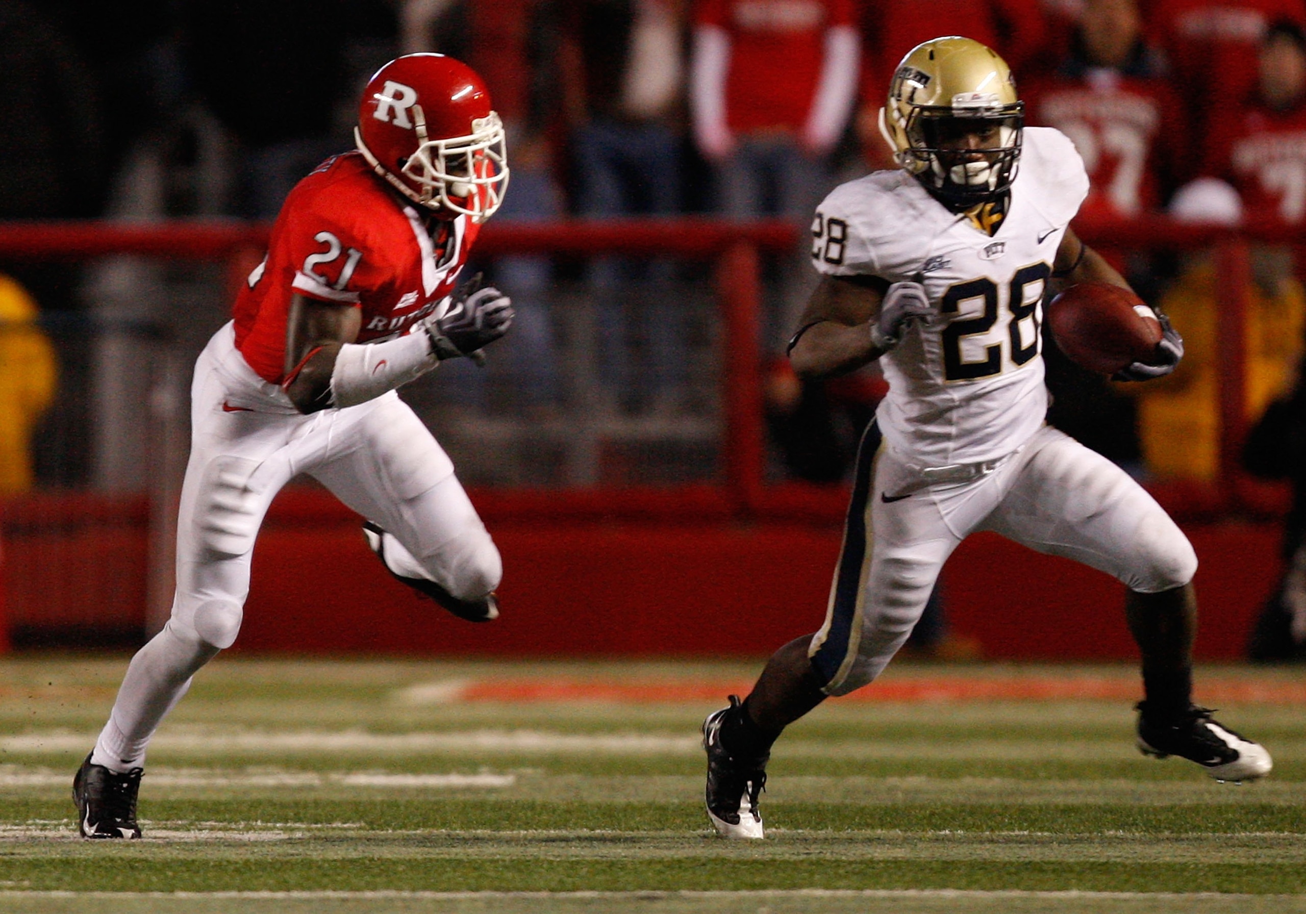 PISCATAWAY, NJ - OCTOBER 16:  Dion Lewis #28 of the University of Pittsburgh Panthers stiff arms Devin Mccourty #21 of the Rutgers University Scarlett Knights on October 16, 2009 at Rutgers Stadium in Piscataway, New Jersey.  (Photo by Jared Wickerham/Get