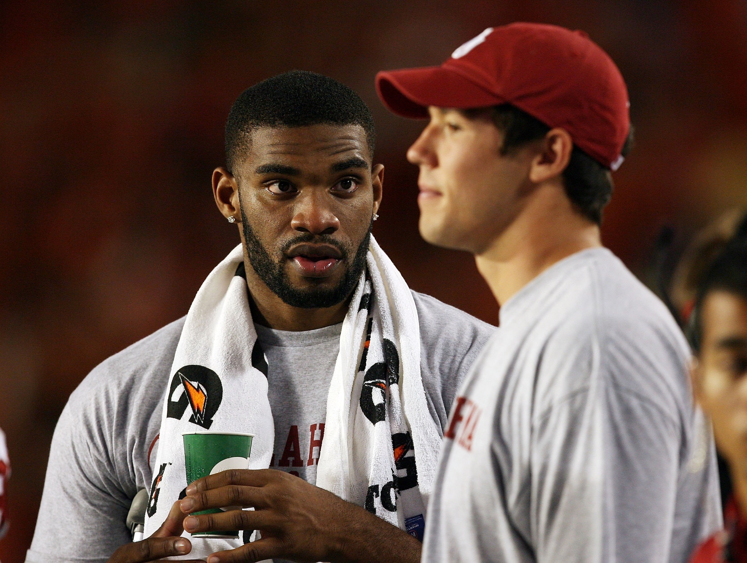 MIAMI GARDENS, FL - OCTOBER 03:  Injured players, tight end Jermaine Gresham #18, L, and quarterback Sam Bradford #14 of the Oklahoma Sooners, talk on the sideline late in the game against the Miami Hurricanes at Land Shark Stadium on October 3, 2009 in M