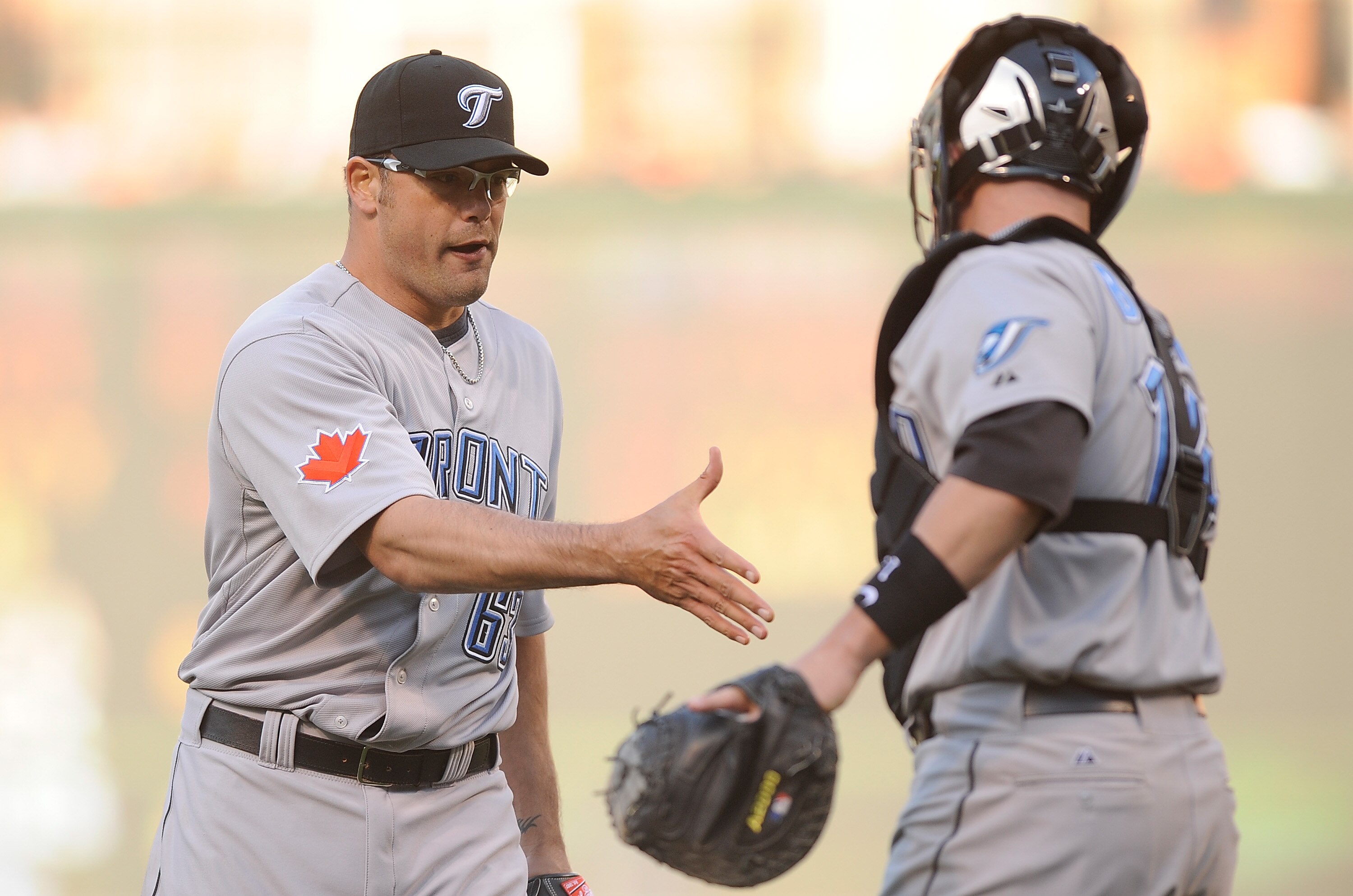 BALTIMORE - APRIL 09:  Kevin Gregg #63 of the Toronto Blue Jays celebrates with John Buck #14 after a 7-6 victory against the Baltimore Orioles on Opening Day at Camden Yards on April 9, 2010 in Baltimore, Maryland.  (Photo by Greg Fiume/Getty Images)