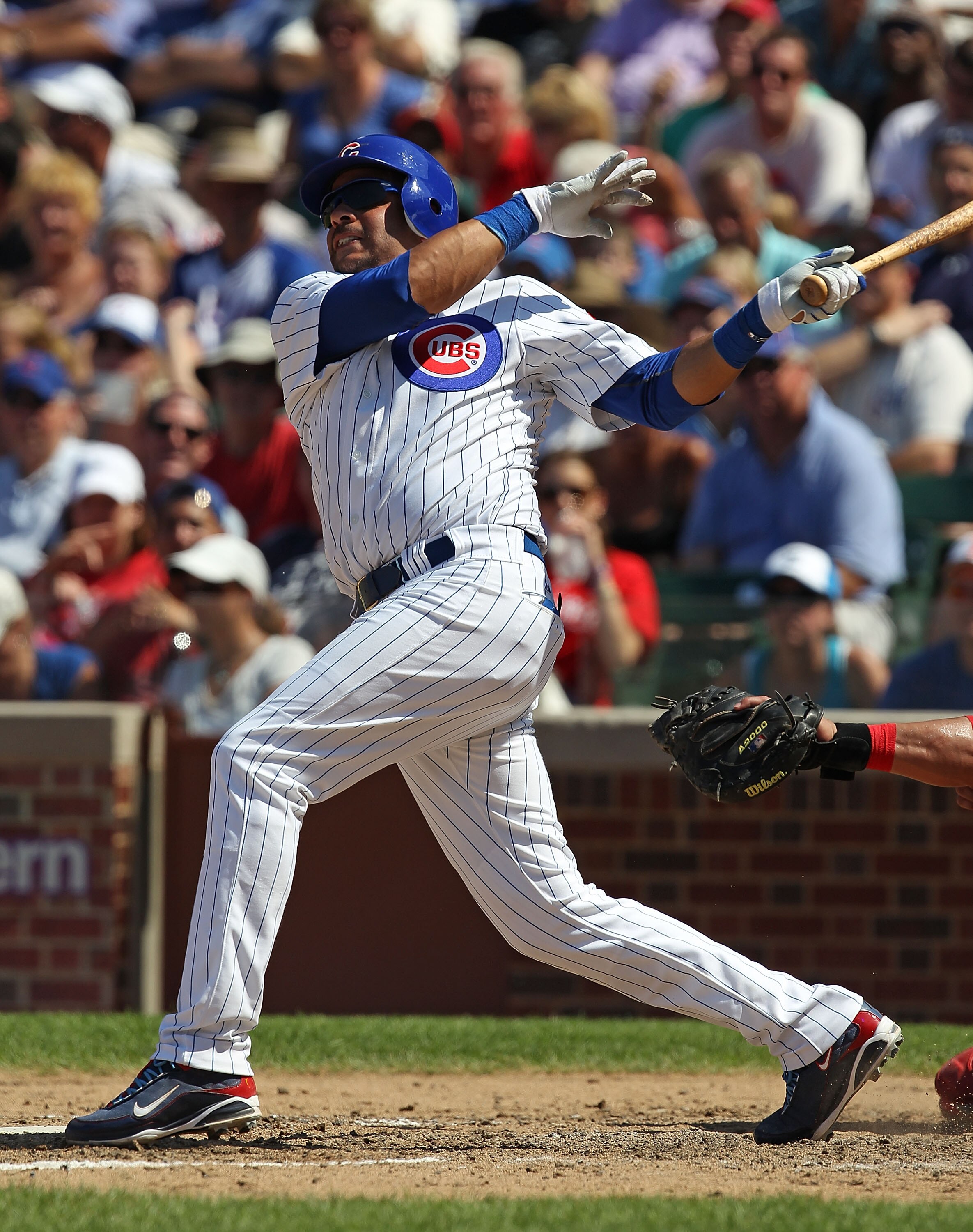 CHICAGO - JULY 16: Aramis Ramirez #16 of the Chicago Cubs hits the game-winning home run, a solo shot in the 8th inning, against the Philadelphia Phillies at Wrigley Field on July 16, 2010 in Chicago, Illinois. The Cubs defeated the Phillies 4-3. (Photo b