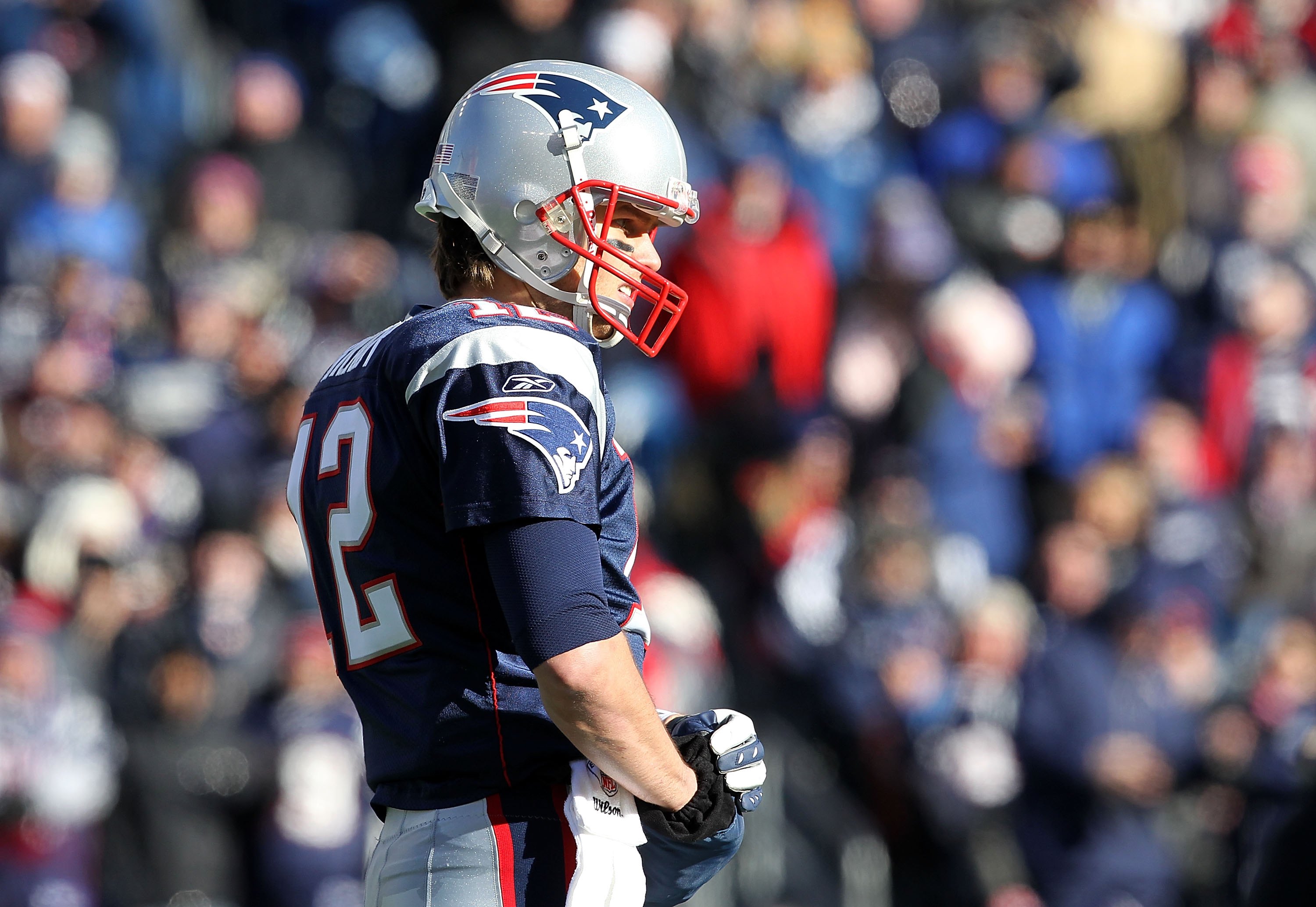 FOXBORO, MA - JANUARY 10:  Tom Brady #12 of the New England Patriots looks on against the Baltimore Ravens during the 2010 AFC wild-card playoff game at Gillette Stadium on January 10, 2010 in Foxboro, Massachusetts. The Ravens won 33-14. (Photo by Jim Ro