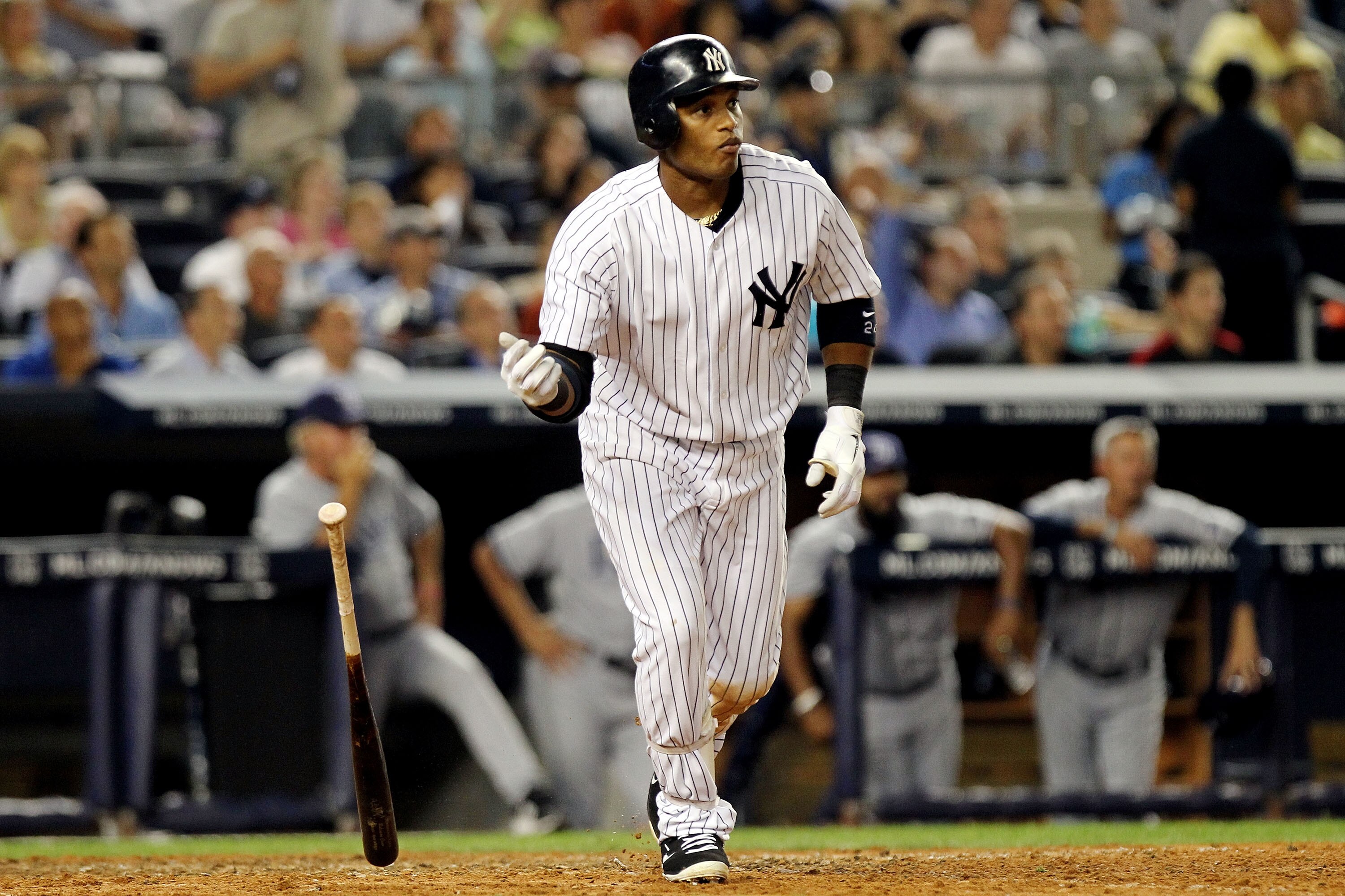 NEW YORK, NY - JULY 07:  Robinson Cano #24 of the New York Yankees hits a solo home run in the first inning against the Tampa Bay Rays at Yankee Stadium on July 7, 2011 in the Bronx borough of New York City.  (Photo by Nick Laham/Getty Images)
