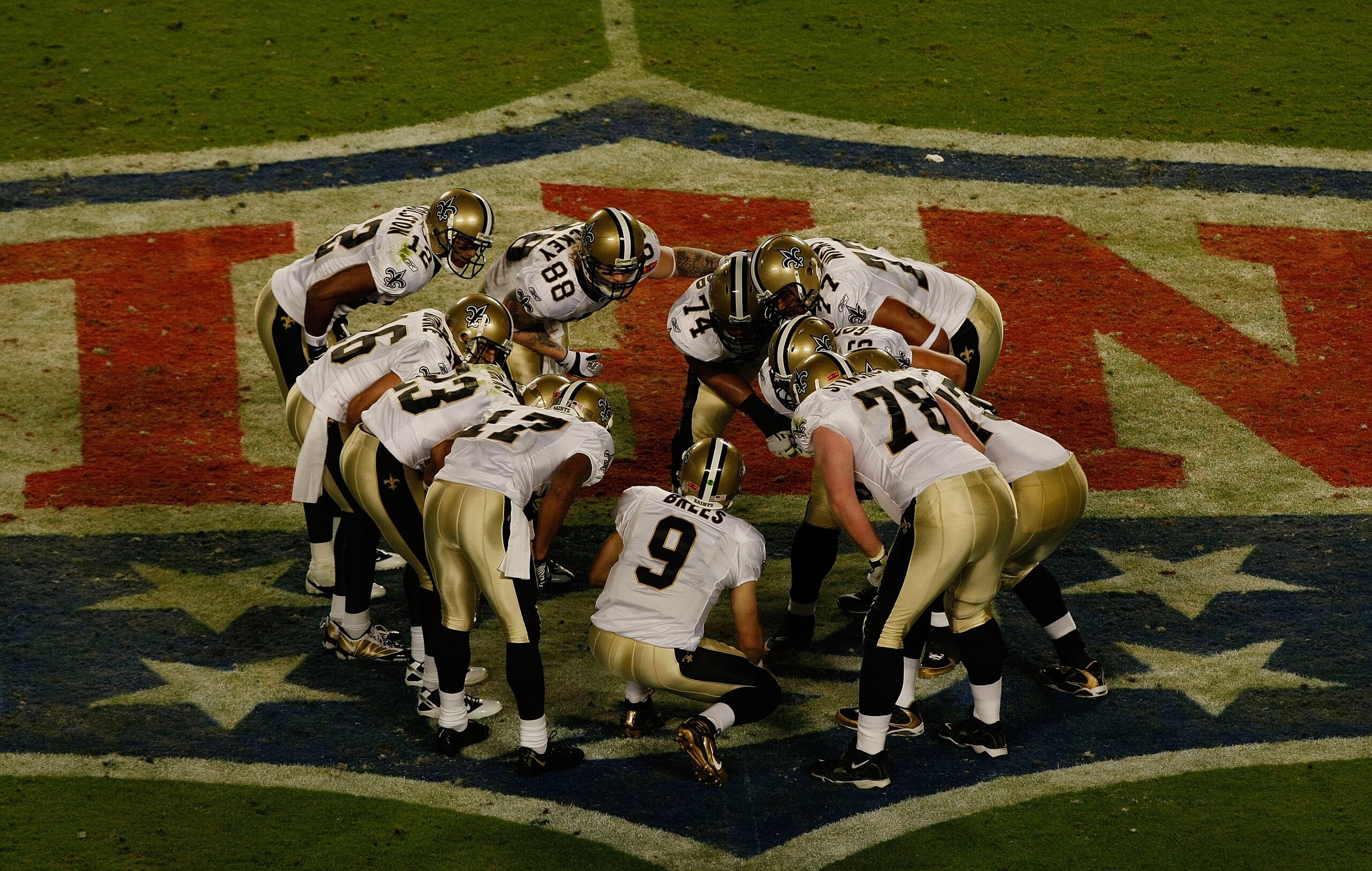 MIAMI GARDENS, FL - FEBRUARY 07:  Drew Brees #9 of the New Orleans Saints talks to his team in the huddle against the Indianapolis Colts during Super Bowl XLIV on February 7, 2010 at Sun Life Stadium in Miami Gardens, Florida.  (Photo by Scott Boehm/Getty