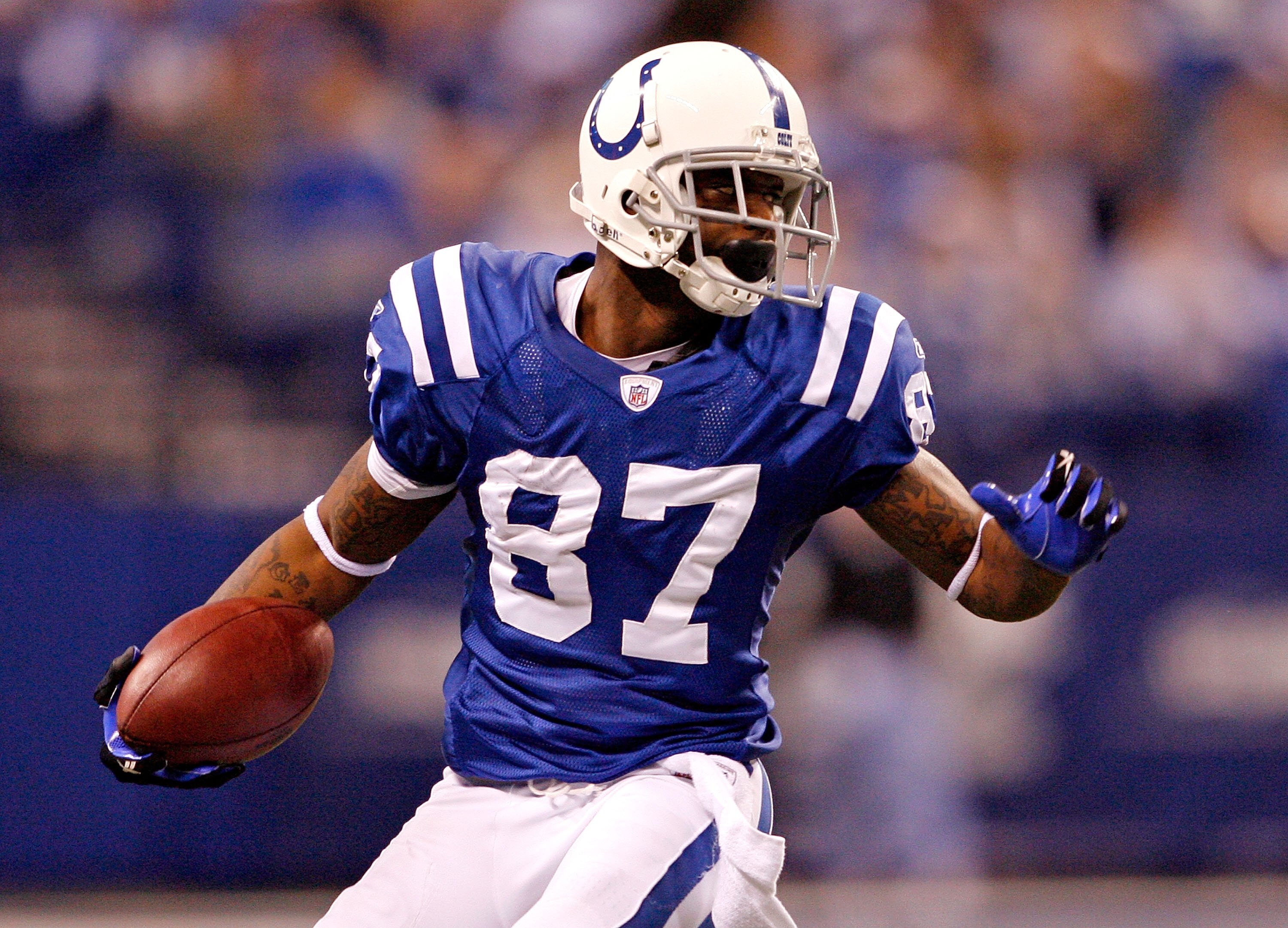 INDIANAPOLIS - DECEMBER 13:   Reggie Wayne #85 of the Indianapolis Colts runs with the ball during the NFL game against the Denver Broncos at Lucas Oil Stadium on December 13, 2009 in Indianapolis, Indiana.  (Photo by Andy Lyons/Getty Images)