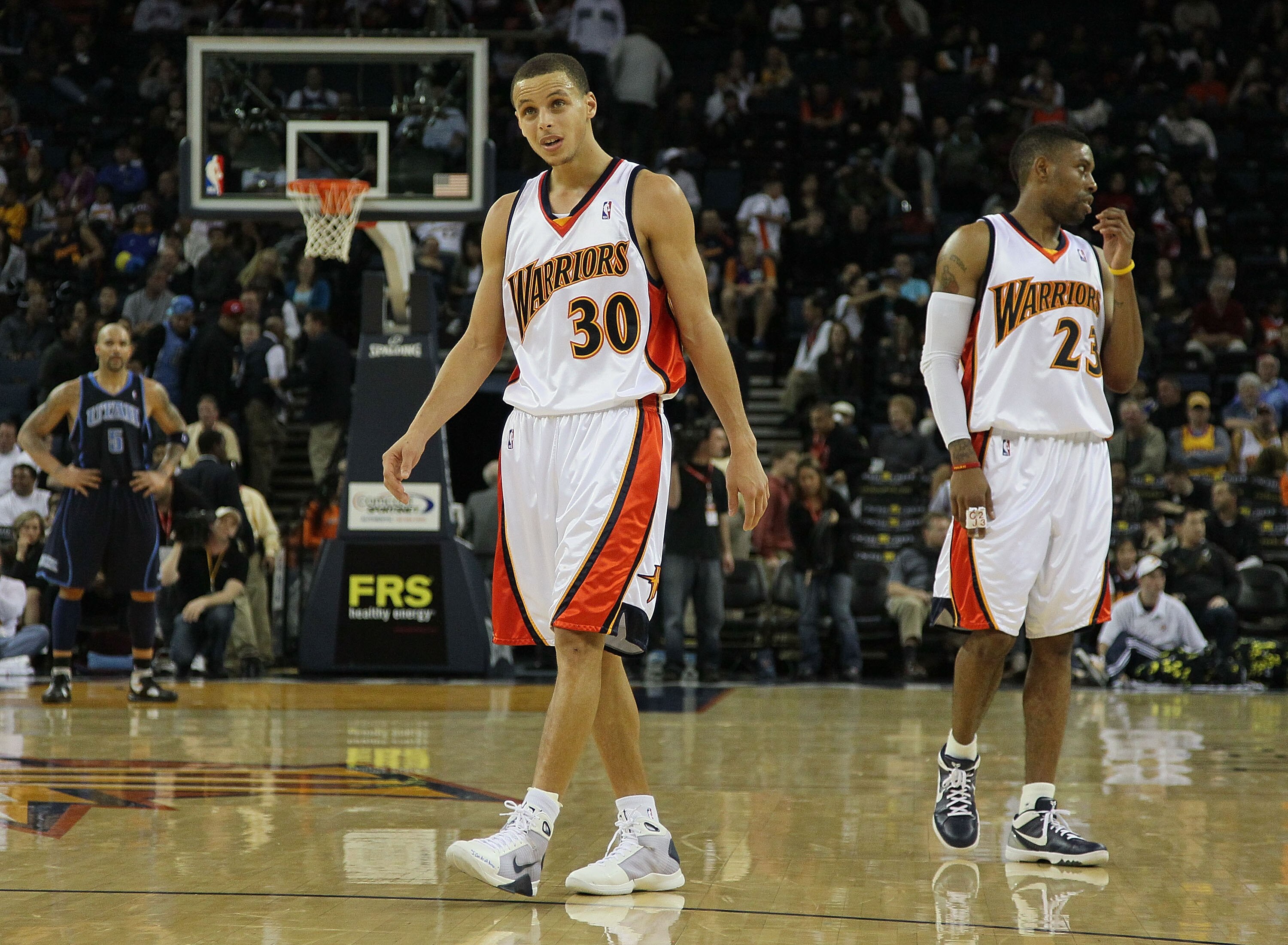 OAKLAND, CA - FEBRUARY 19:  Stephen Curry #30 and C.J. Watson #23 of the Golden State Warriors look on against the Utah Jazz during an NBA game at Oracle Arena at Oracle Arena on February 19, 2010 in Oakland, California.  NOTE TO USER: User expressly ackn