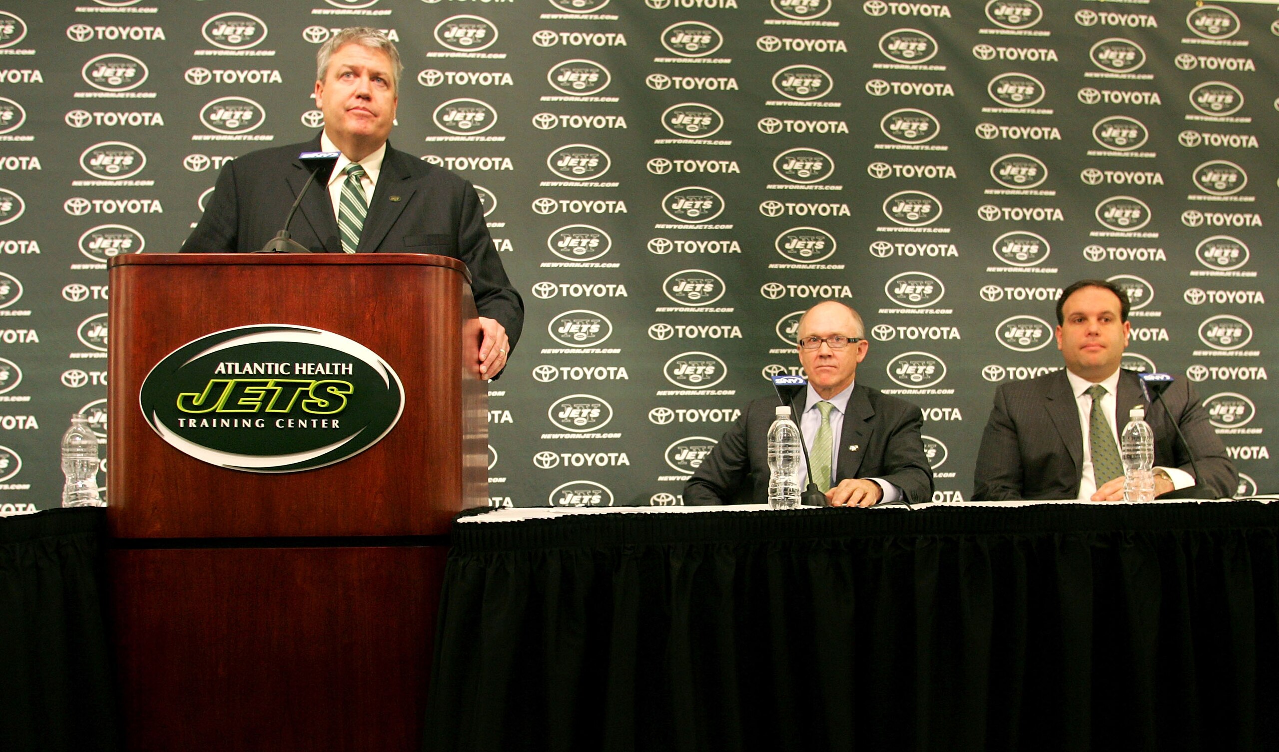 FLORHAM PARK, NJ - JANUARY 21: Rex Ryan  addresses the media during a press conference introducing him as the new Head Coach of the New York Jets as Owner Woody Johnson (C) and General Manager Mike Tannenbaum look on at the Atlantic Health Jets Training C