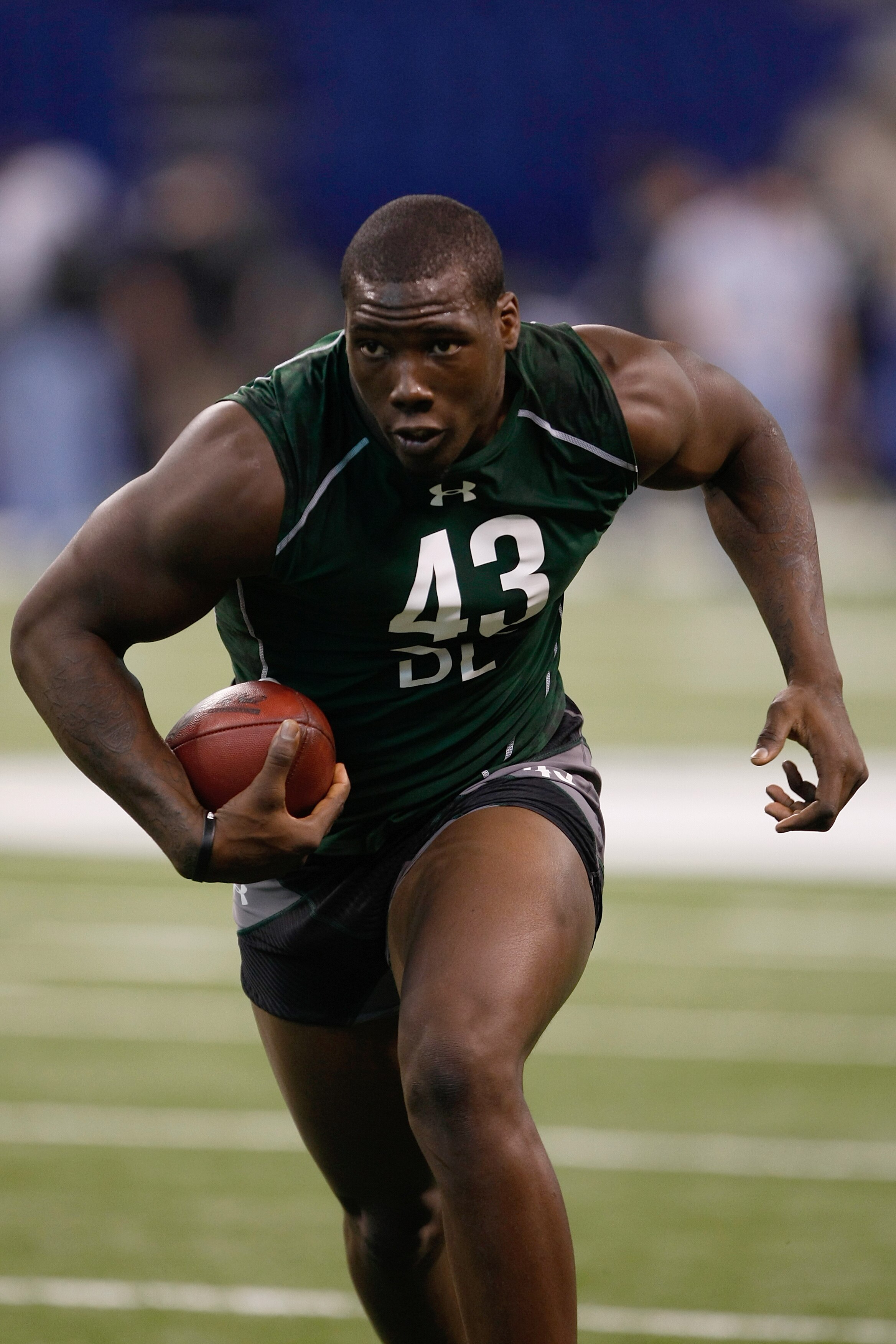 INDIANAPOLIS, IN - MARCH 1: Defensive lineman Jason Pierre-Paul of South Florida runs with the football in drills during the NFL Scouting Combine presented by Under Armour at Lucas Oil Stadium on March 1, 2010 in Indianapolis, Indiana. (Photo by Scott Boe