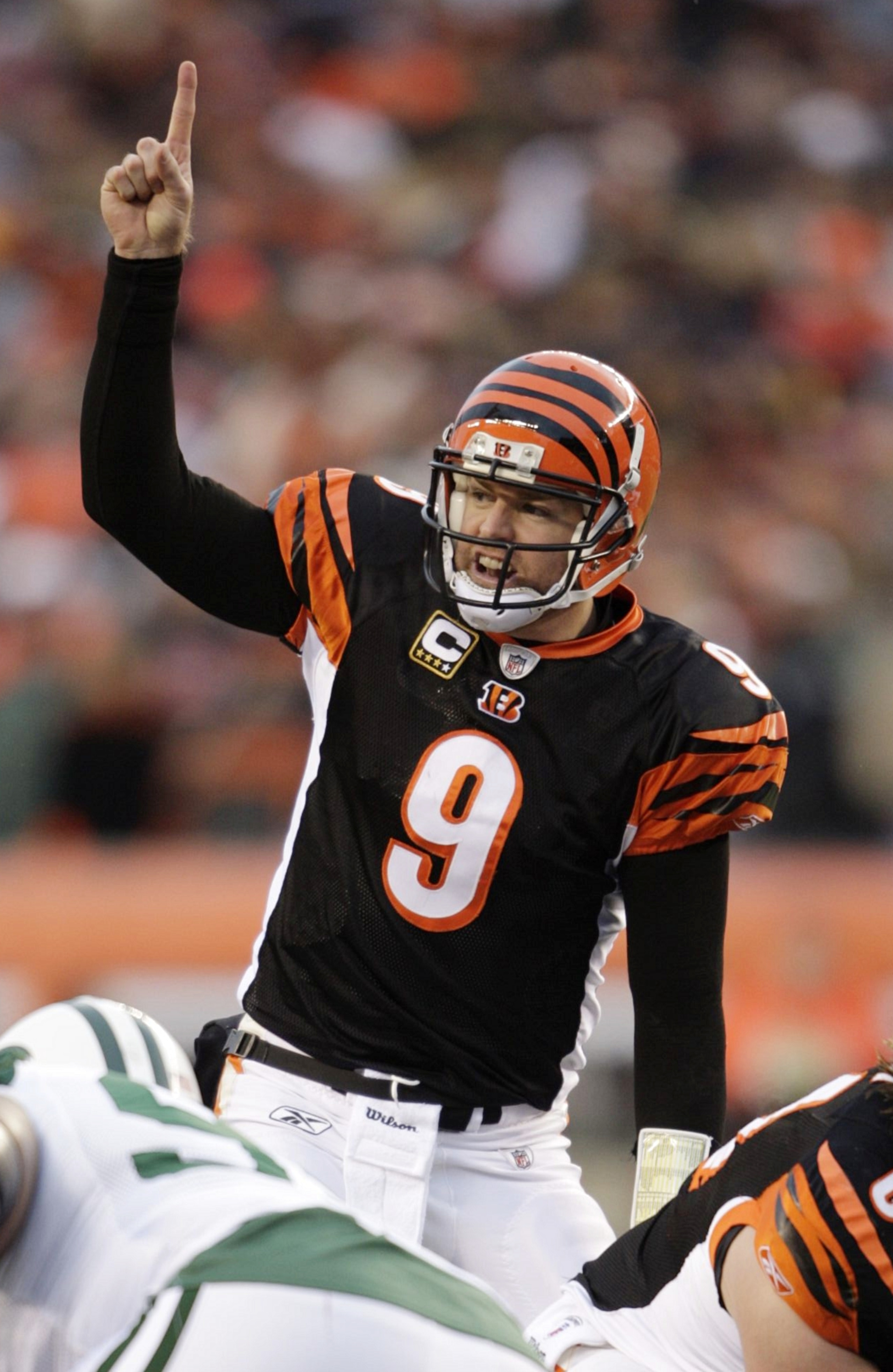 CINCINNATI - JANUARY 9:  Quarterback Carson Palmer #9 of the Cincinnati Bengals signals at the line of scrimmage against the New York Jets during the 2010 AFC wild-card playoff game at Paul Brown Stadium on January 9, 2010 in Cincinnati, Ohio. (Photo by A